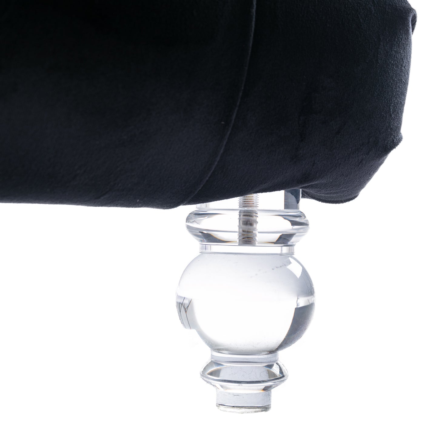 Black velvet armchair detail with clear acrylic ball leg and silver screw fixture