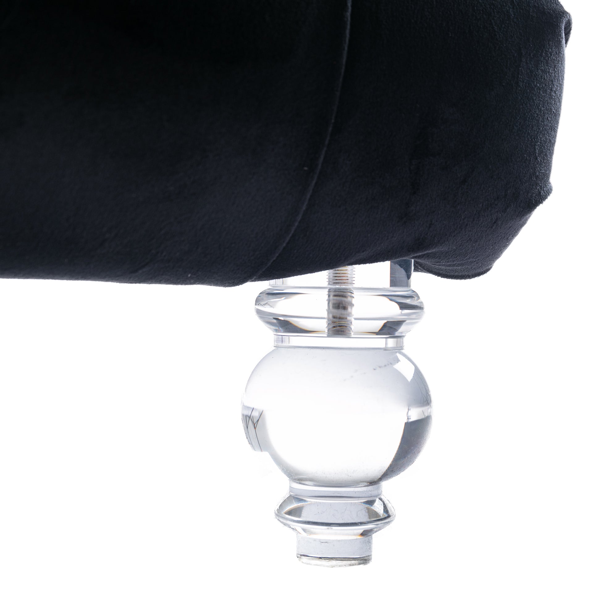 Black velvet armchair detail with clear acrylic ball leg and silver screw fixture
