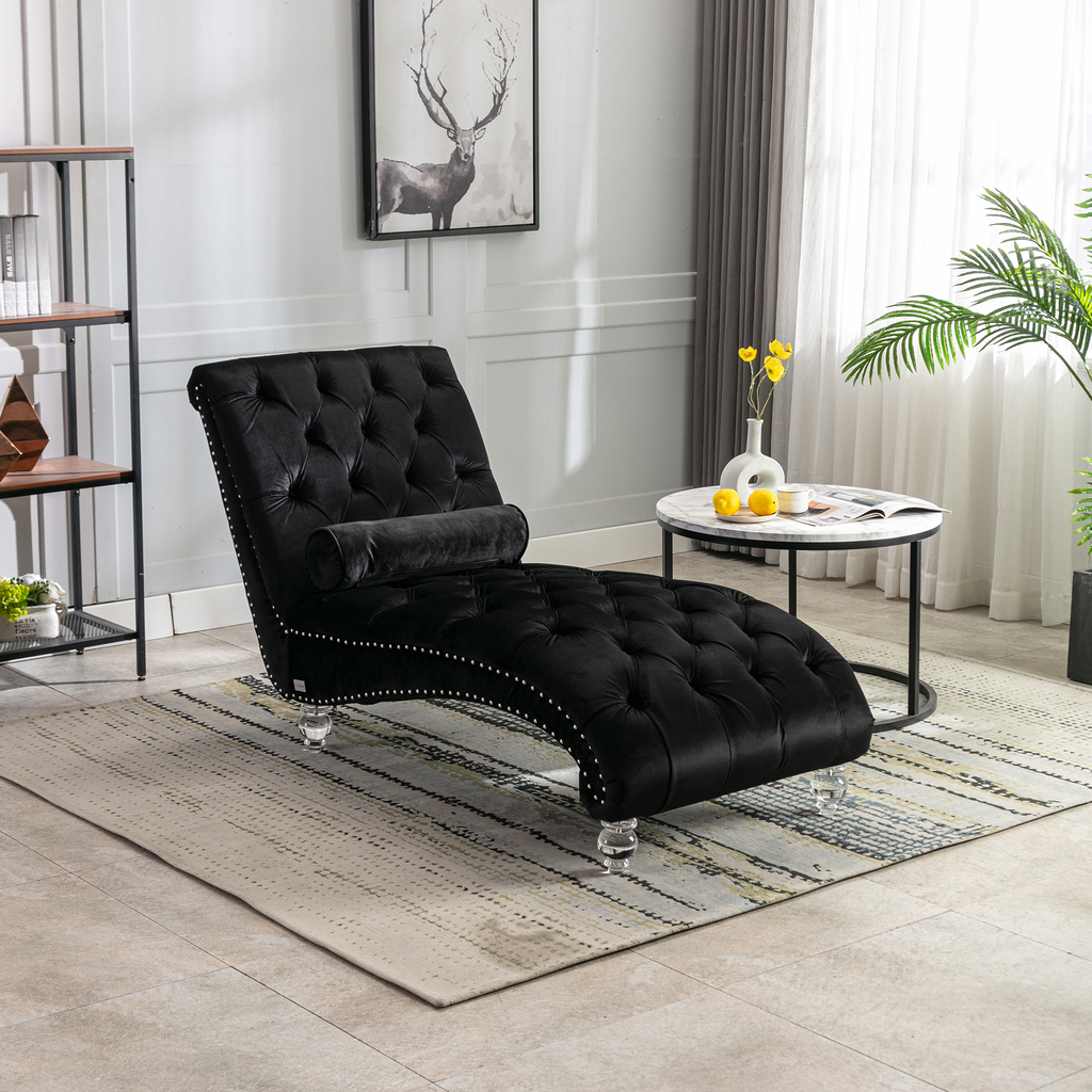 Black velvet chaise lounge with tufted back and crystal legs for elegant relaxation