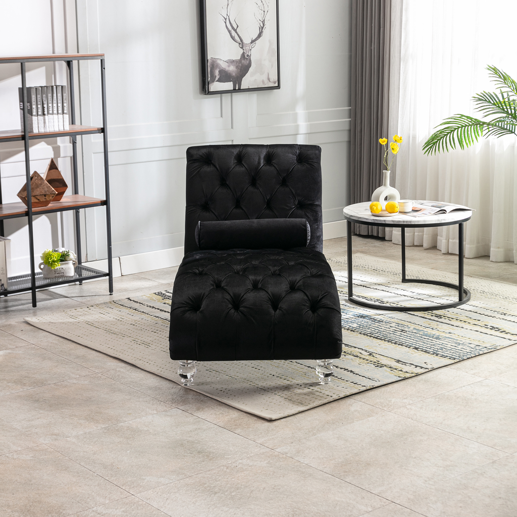 Plush black velvet chaise lounge with diamond tufting and clear acrylic legs