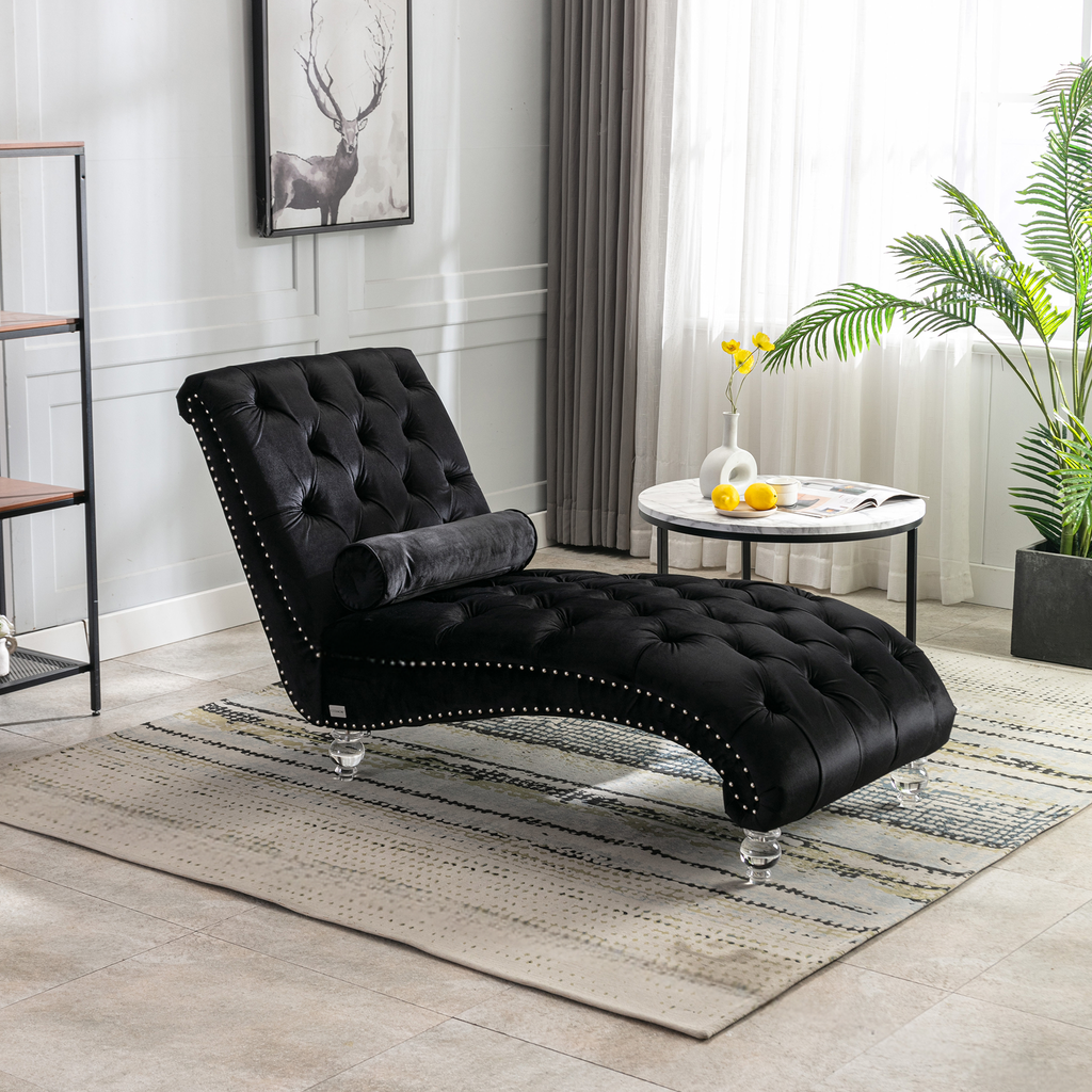 Black velvet tufted chaise lounge with silver nailhead trim and acrylic legs perfect for relaxation