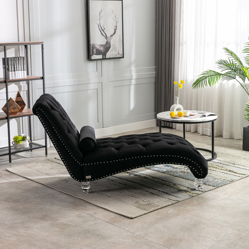 Black velvet chaise lounge with tufted upholstery and silver nailhead trim