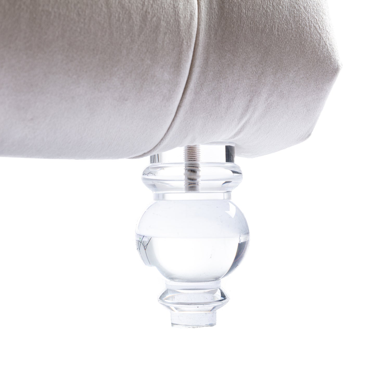 Cream fabric sofa with clear acrylic furniture leg detail