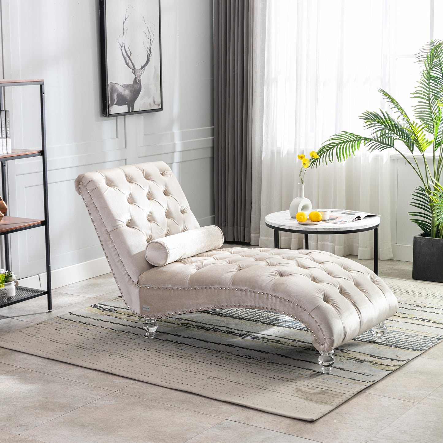 Elegant beige velvet chaise lounge with button tufting and silver nailhead trim perfect for a living room accent piece
