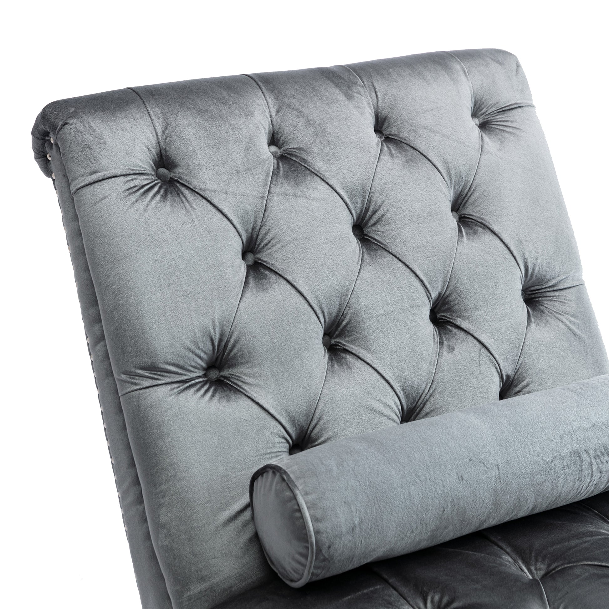Tufted grey velvet chaise lounge with bolster pillow for luxurious relaxation