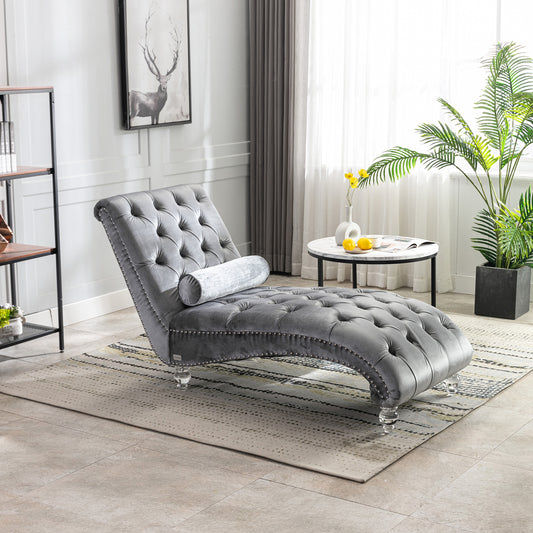 Gray velvet tufted chaise lounge with silver nailhead trim and clear acrylic legs for stylish living room accent