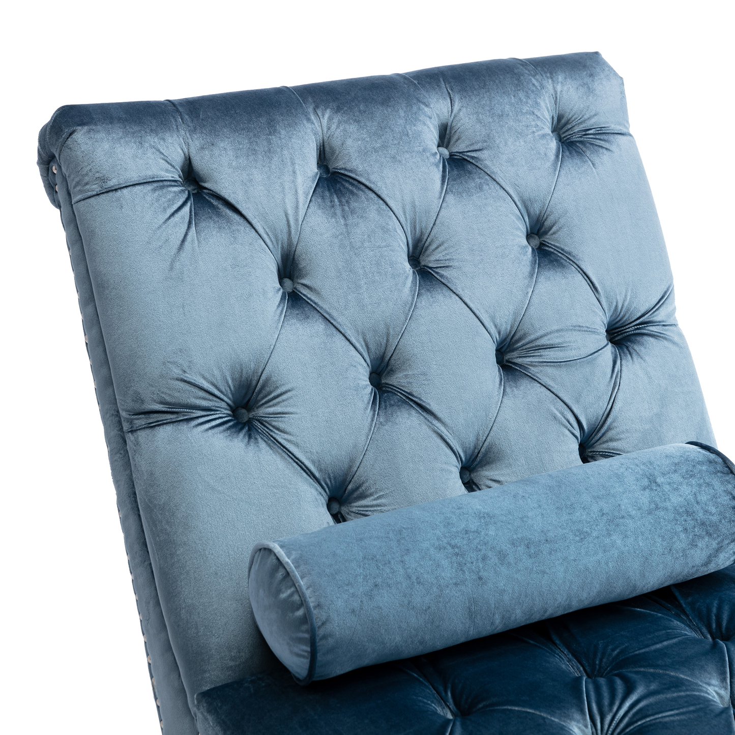 Closeup of a blue velvet tufted chaise lounge with bolster pillow