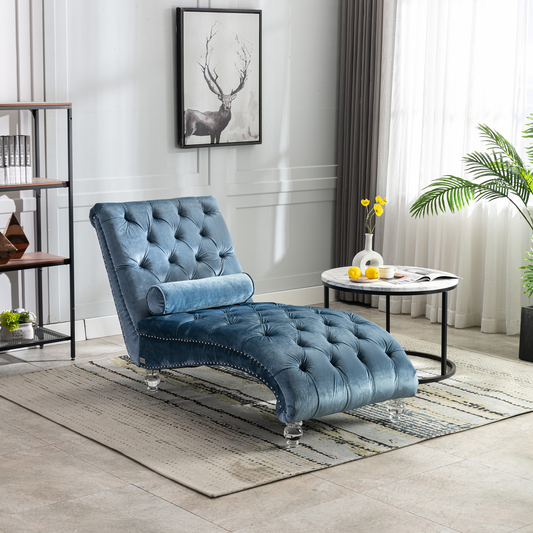 Tufted blue velvet chaise lounge with silver nailhead trim and crystal legs