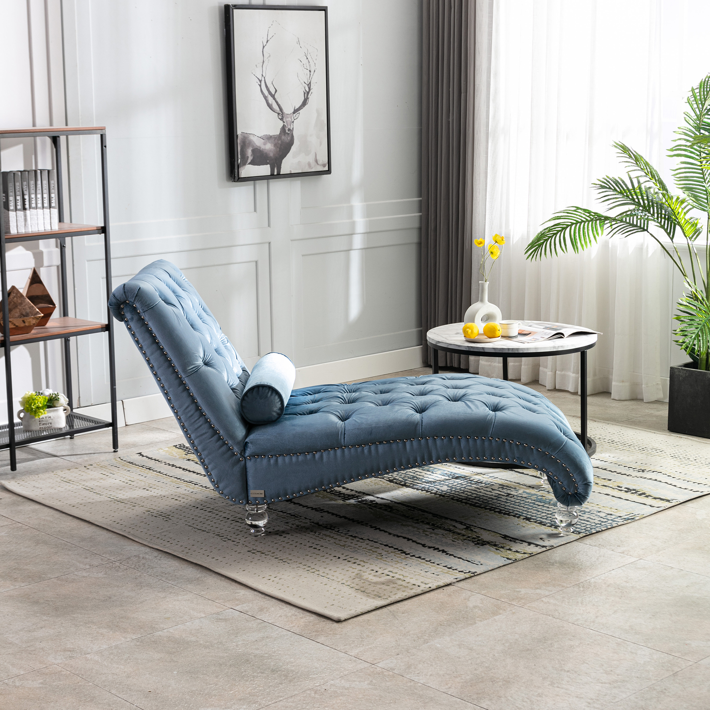 Blue velvet tufted chaise lounge with silver nailhead trim and acrylic legs perfect for relaxation