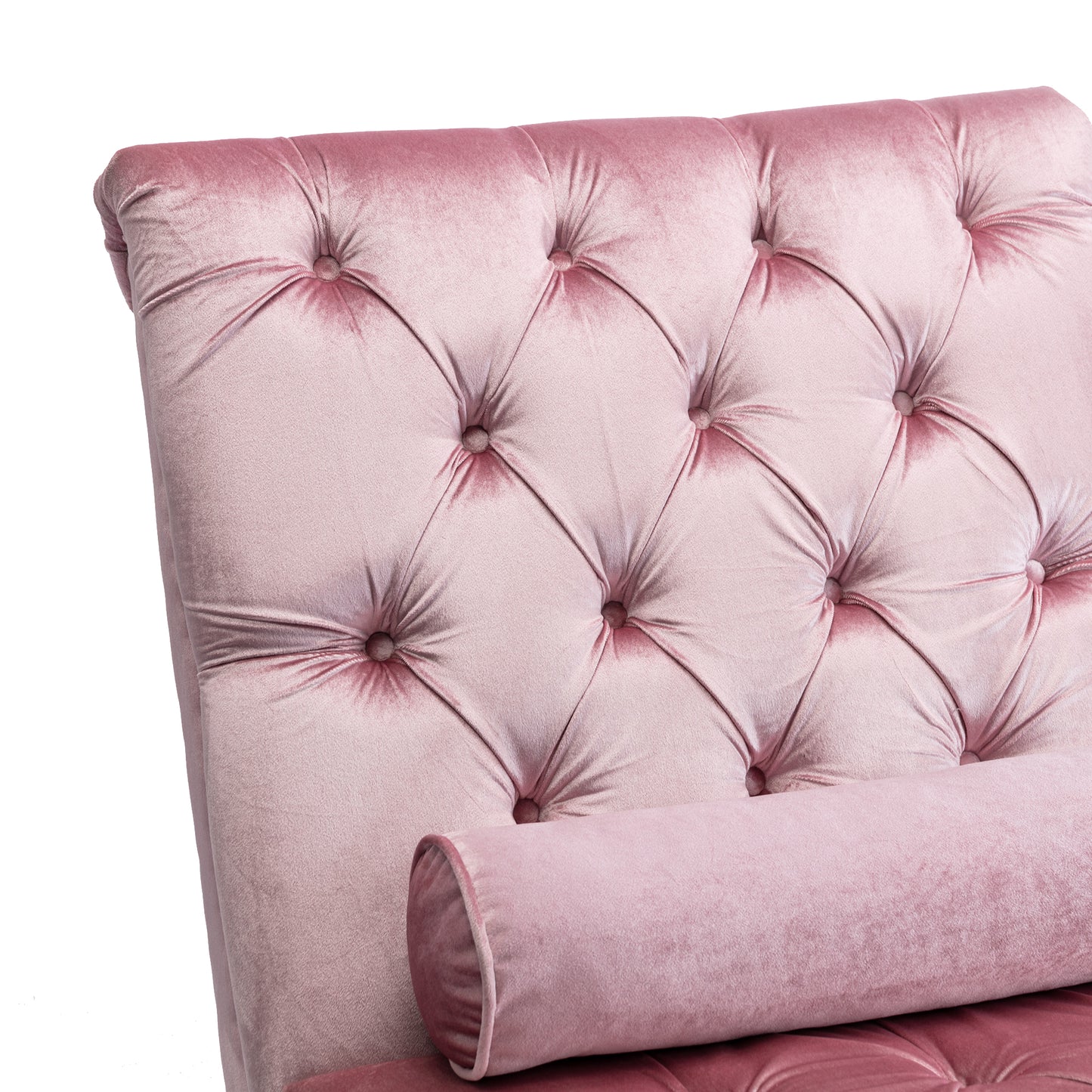 Closeup of plush pink velvet tufted armchair with a bolster pillow