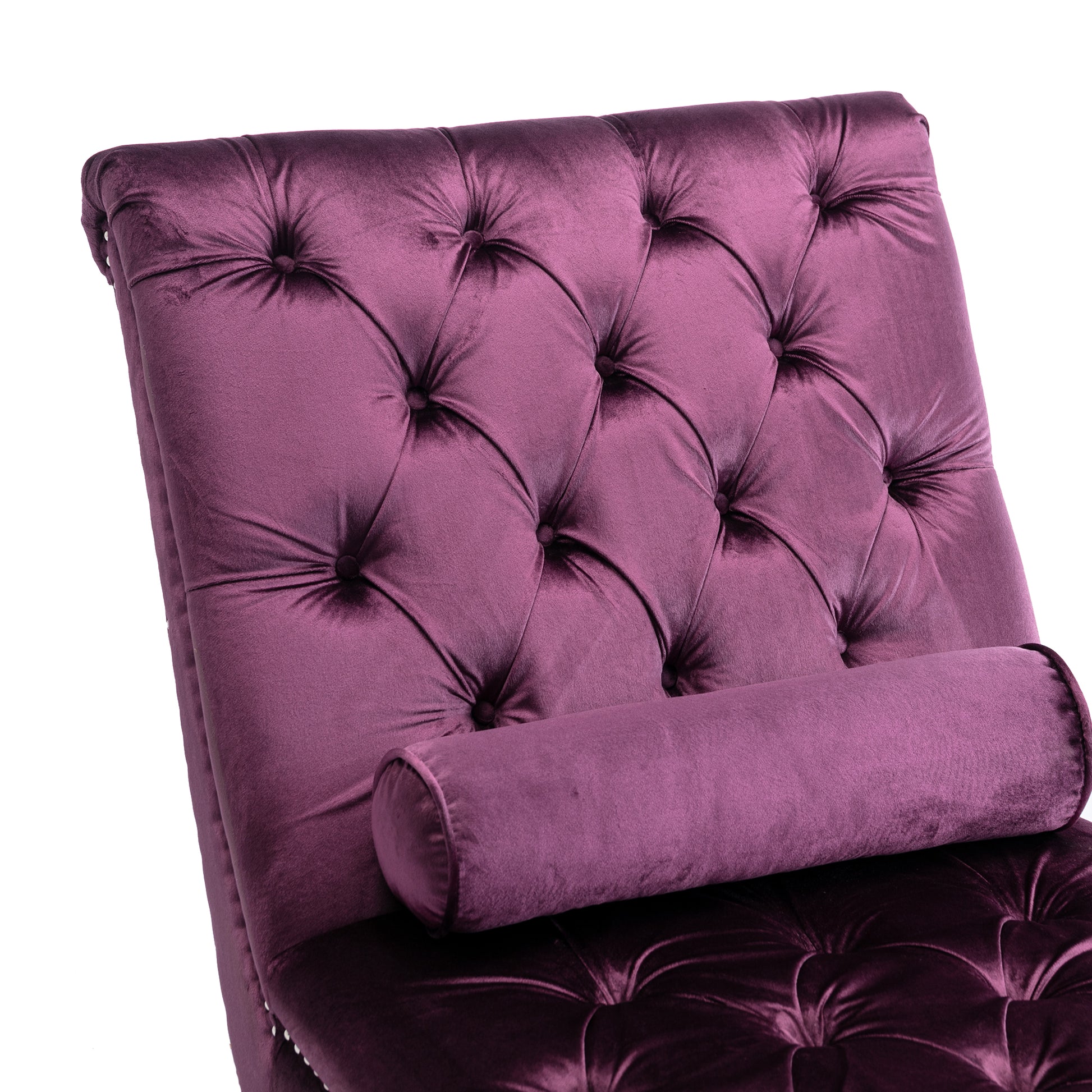 Plush purple velvet chaise lounge with tufted back and bolster pillow