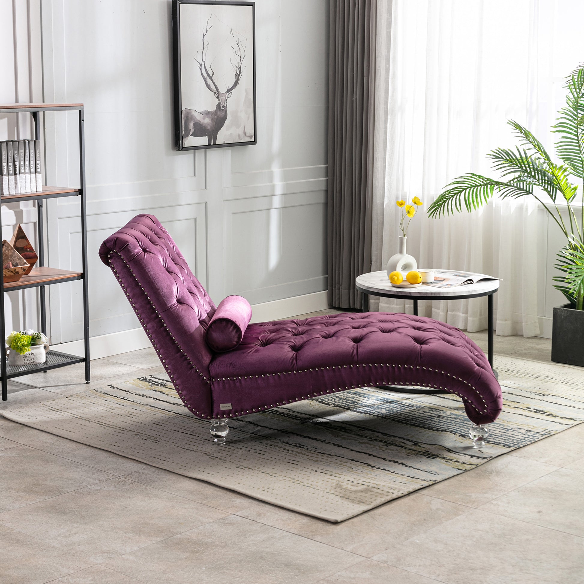 Plush purple velvet chaise lounge with tufted details and silver nailhead trim for stylish relaxation