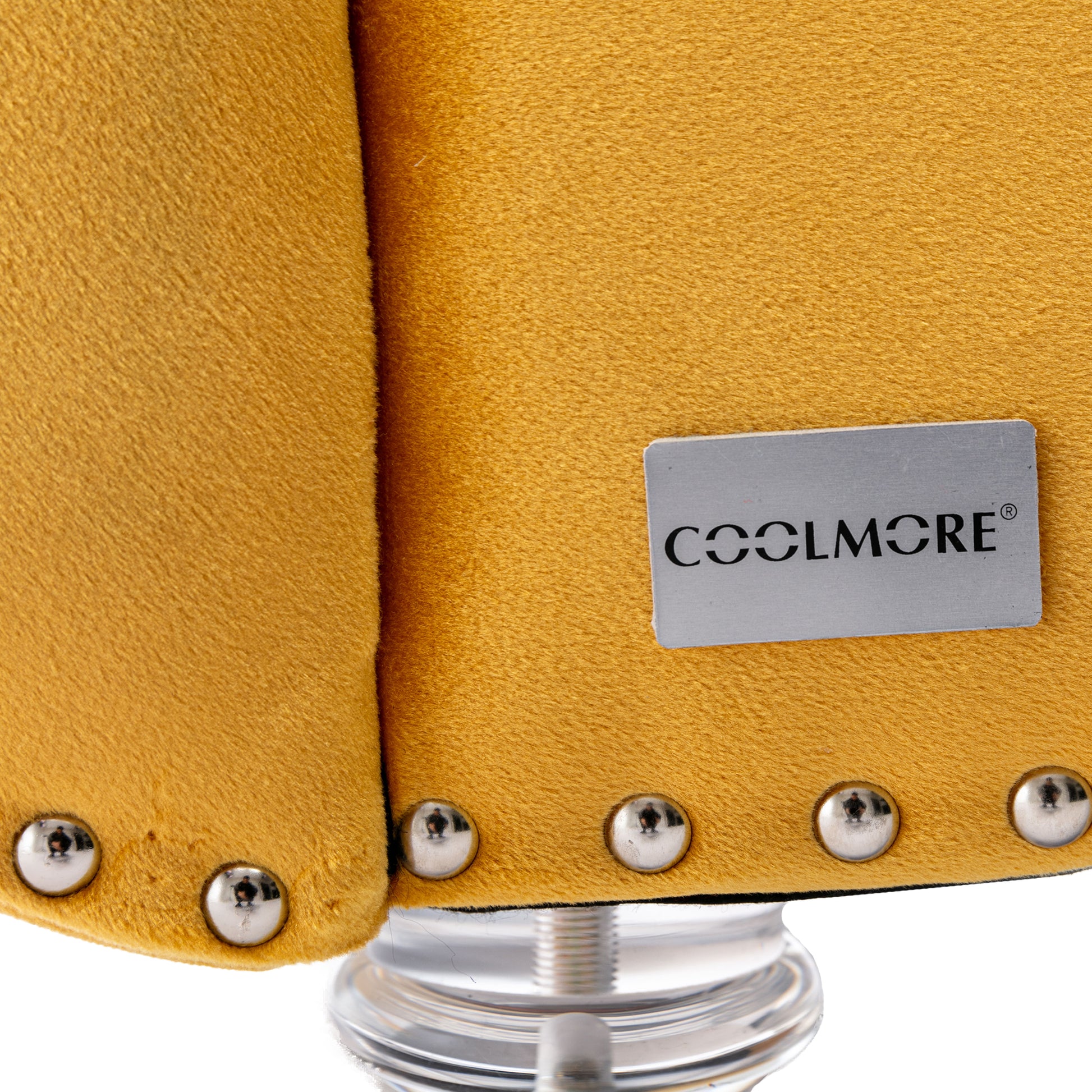 Closeup of mustard yellow velvet upholstery with silver nailhead trim