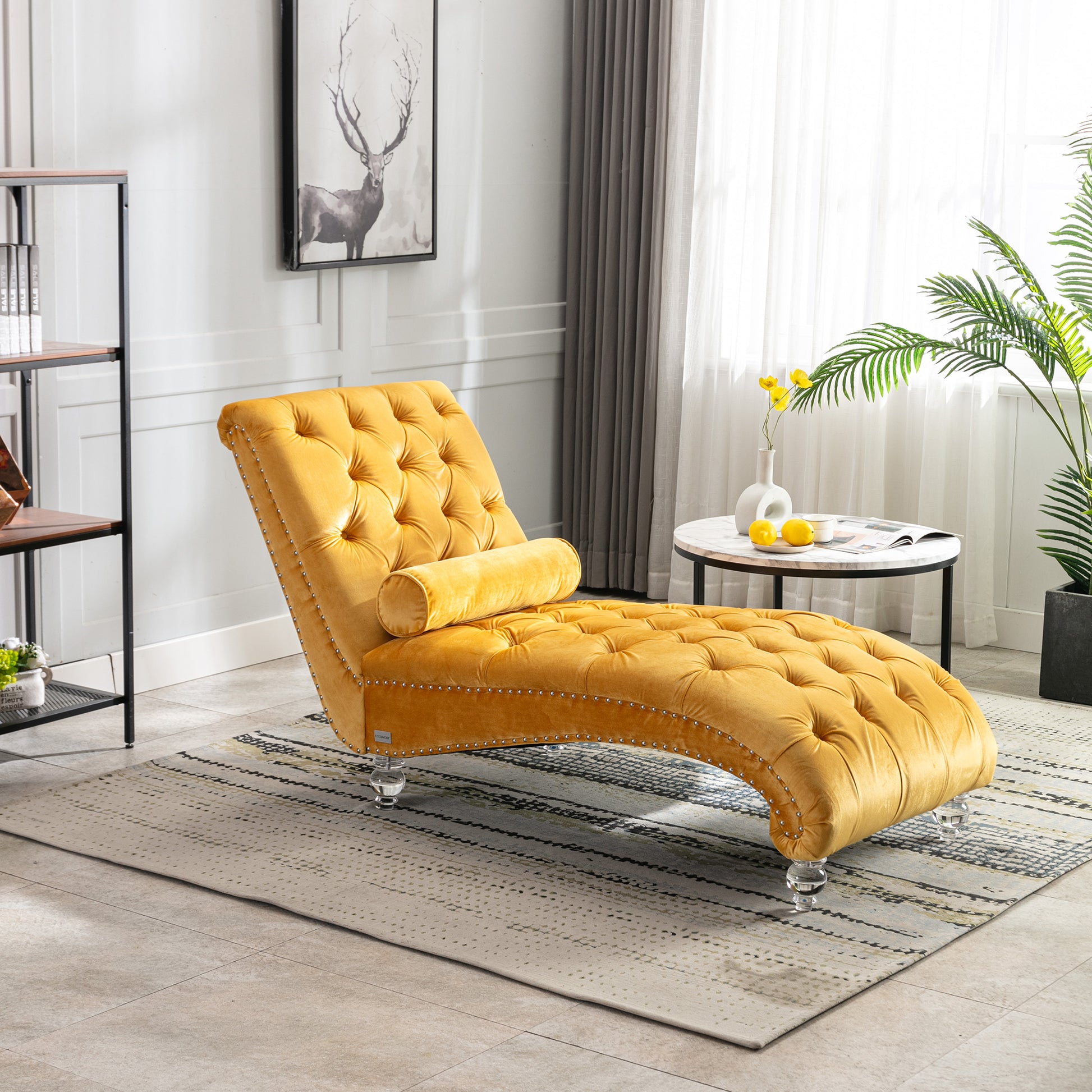 Yellow velvet chaise lounge with tufted details and silver nailhead trim