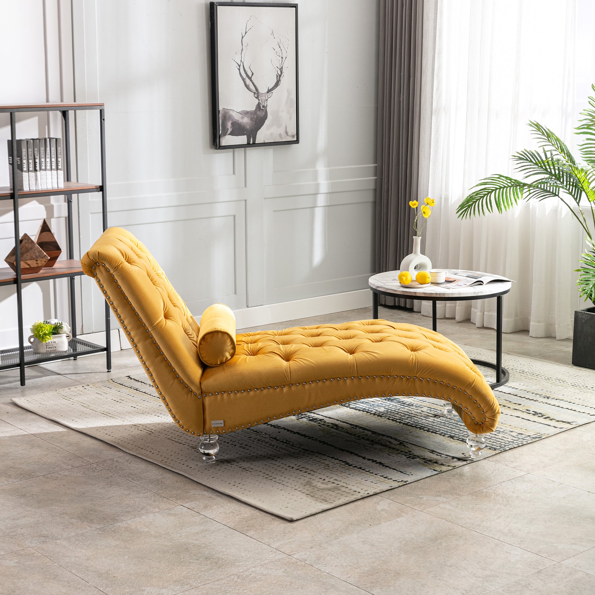 Yellow velvet chaise lounge with tufted design and silver nailhead trim