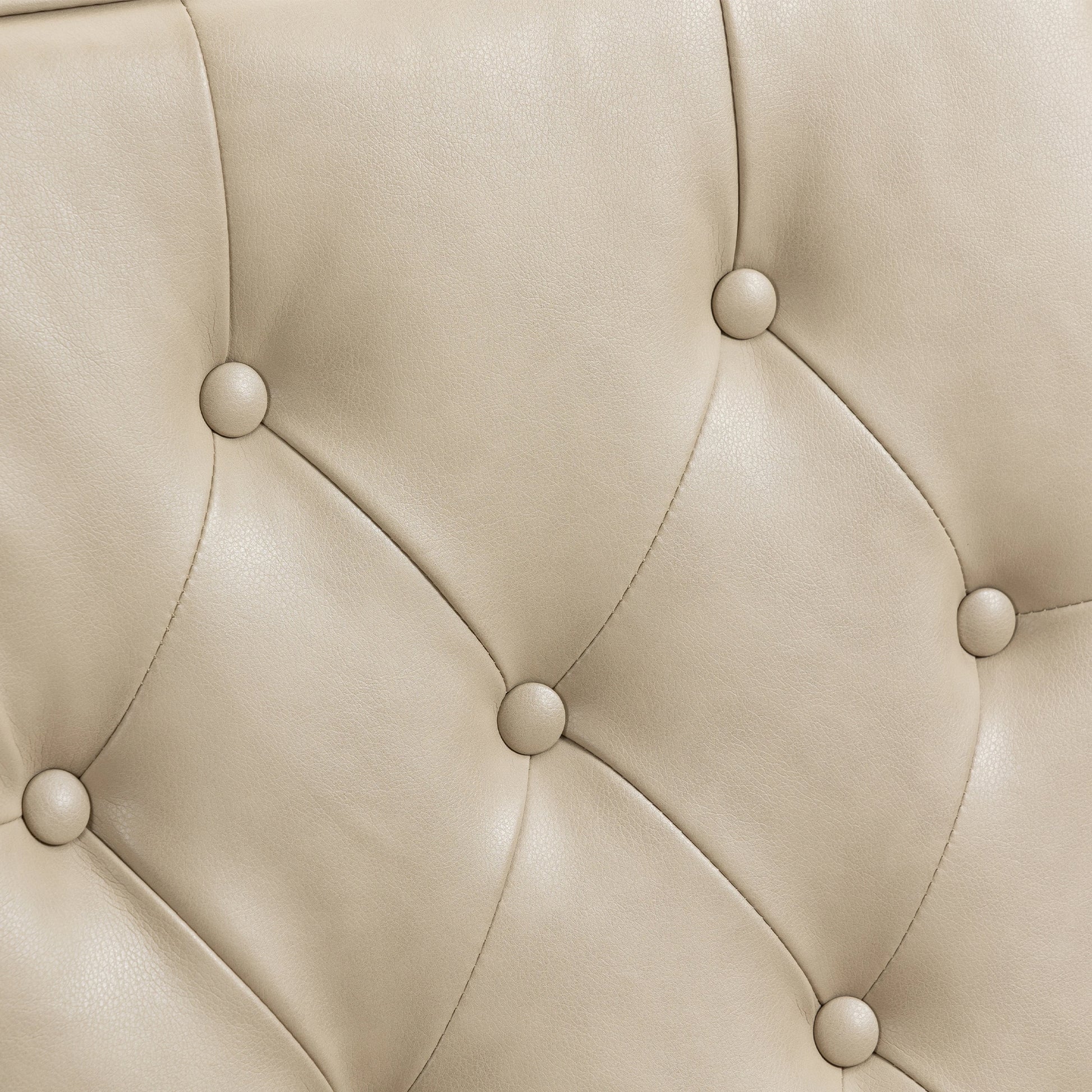 Closeup of beige faux leather tufted upholstery with button accents
