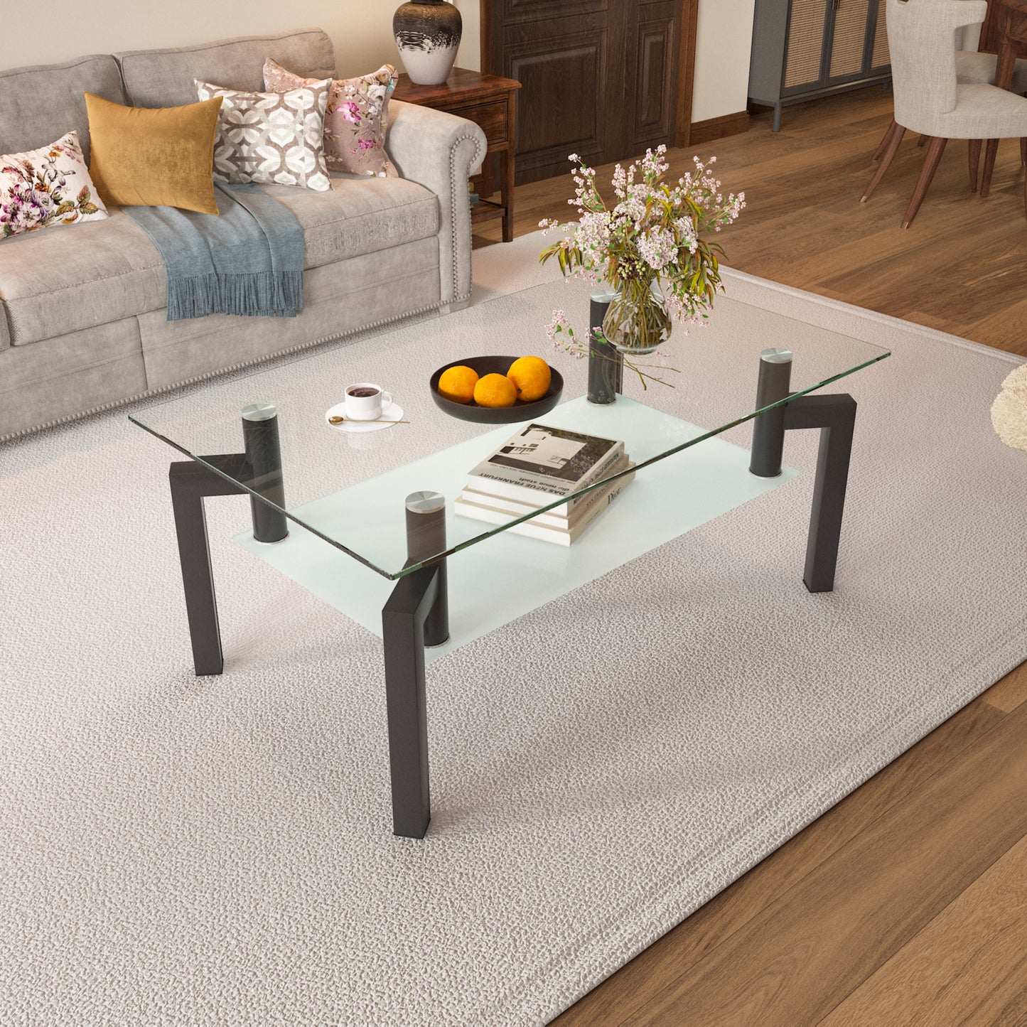Modern glass coffee table with dark metal legs and a stack of books
