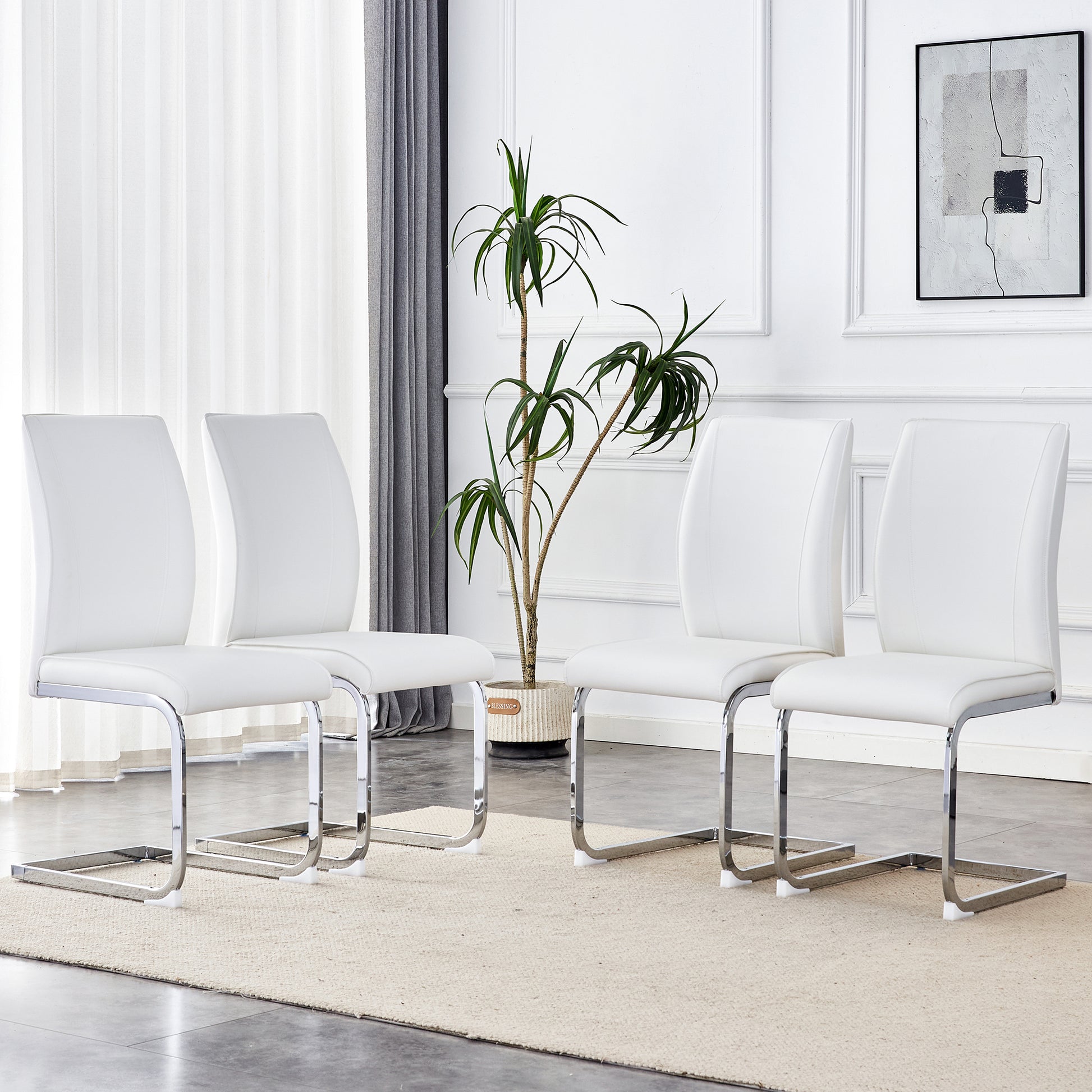 Set of four white faux leather dining chairs with chrome sled bases