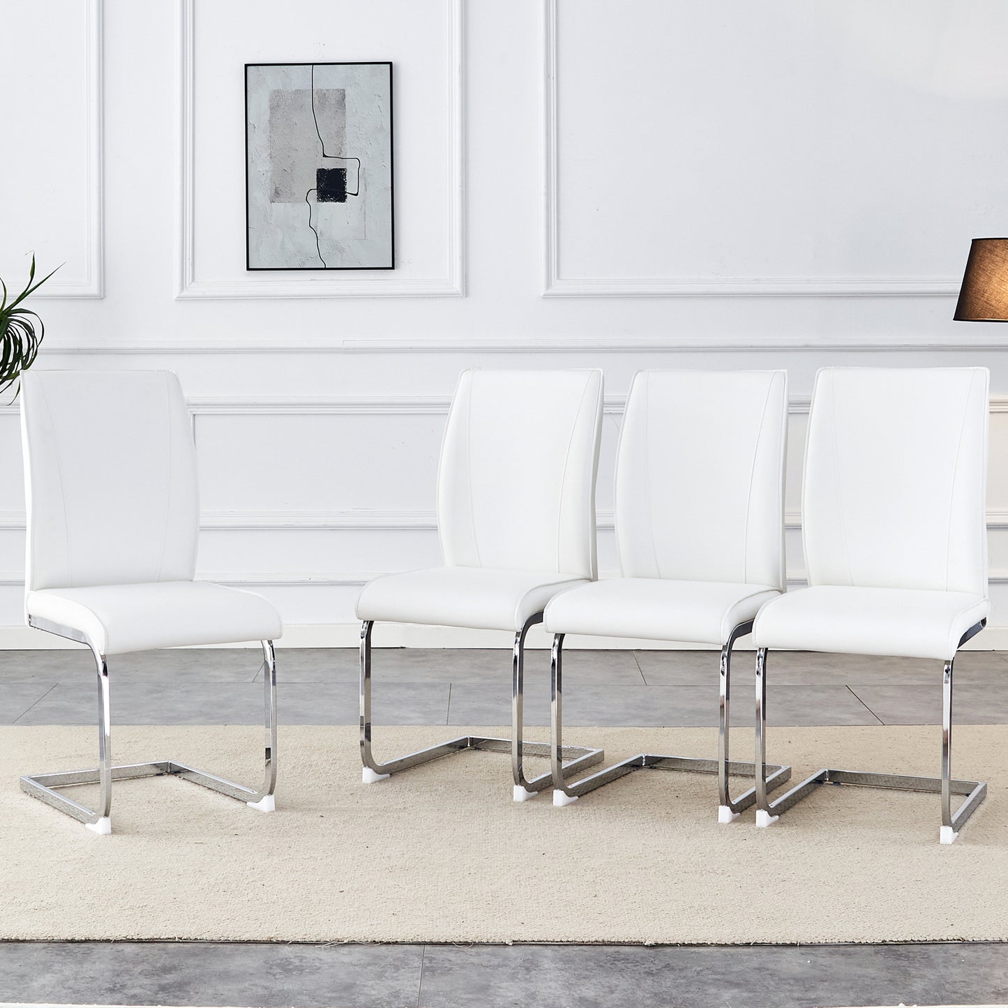 Set of  modern white faux leather dining chairs with chrome sled legs