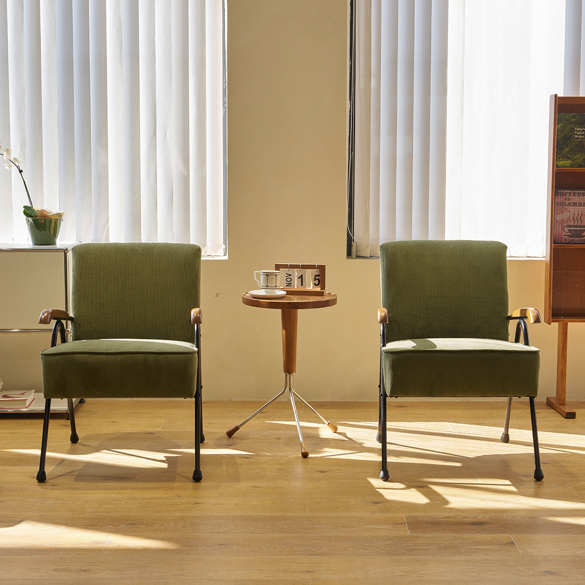 Classic olive green armchair with wooden arms and black metal legs