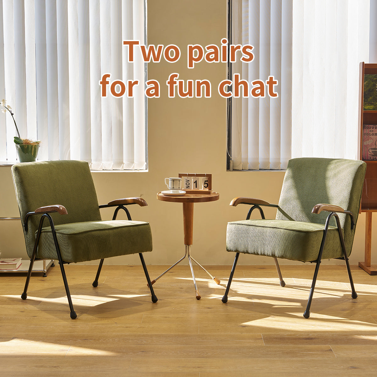 Green corduroy armchair with wooden armrests and black metal legs perfect for a reading nook
