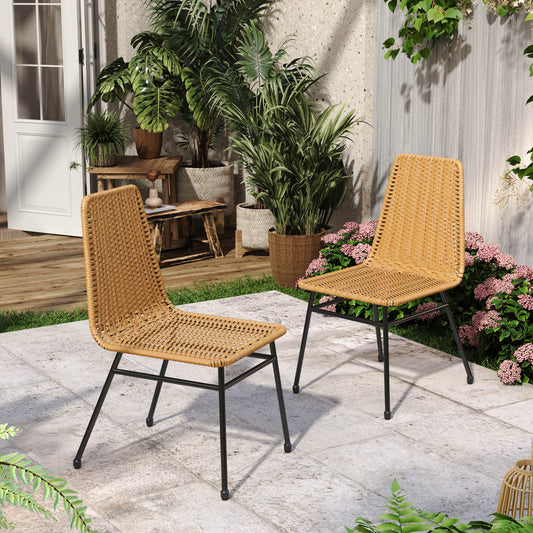 Natural rattan dining chair with black metal legs on patio