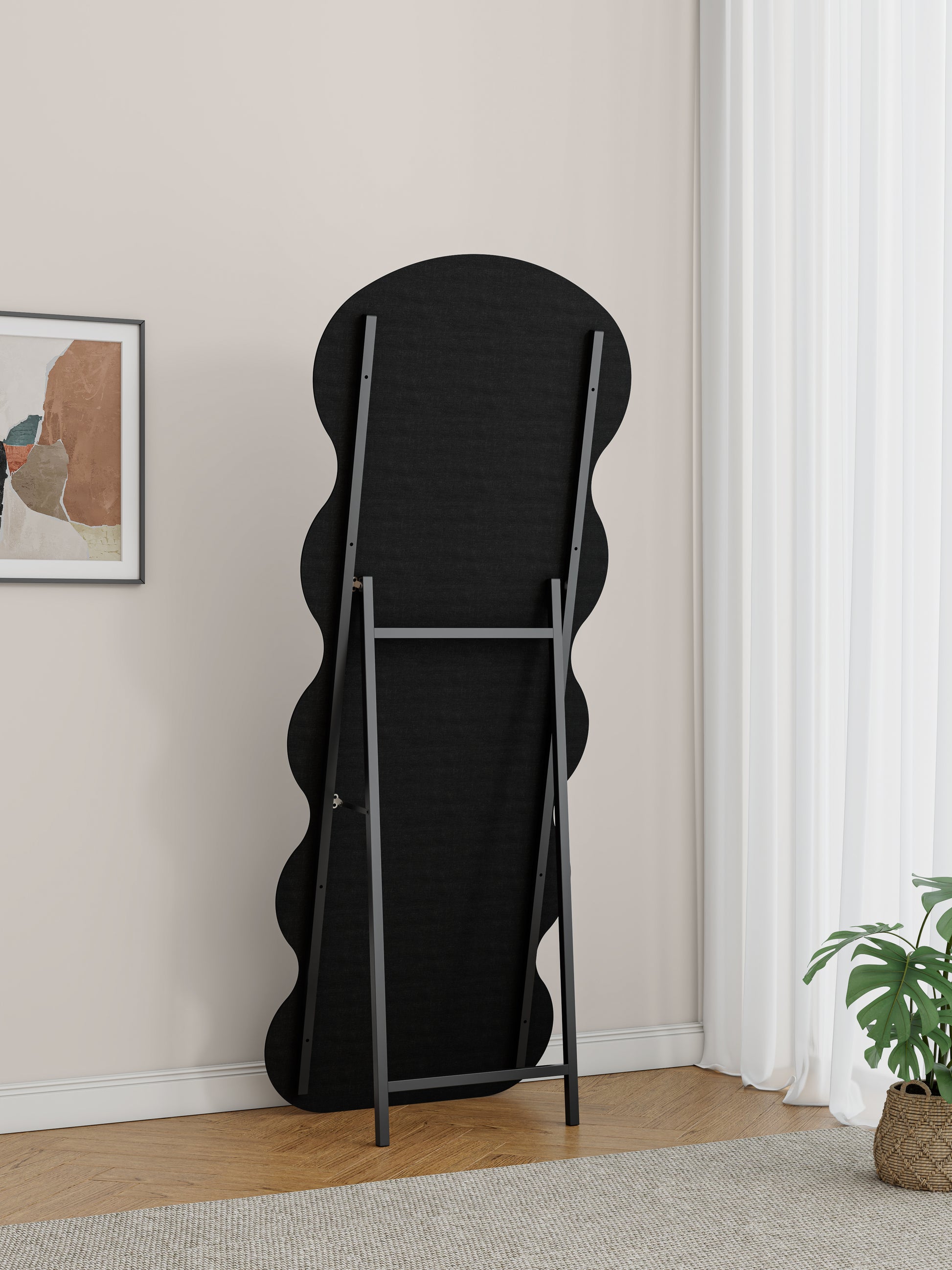 Back view of a black wavy fulllength mirror with a metal stand