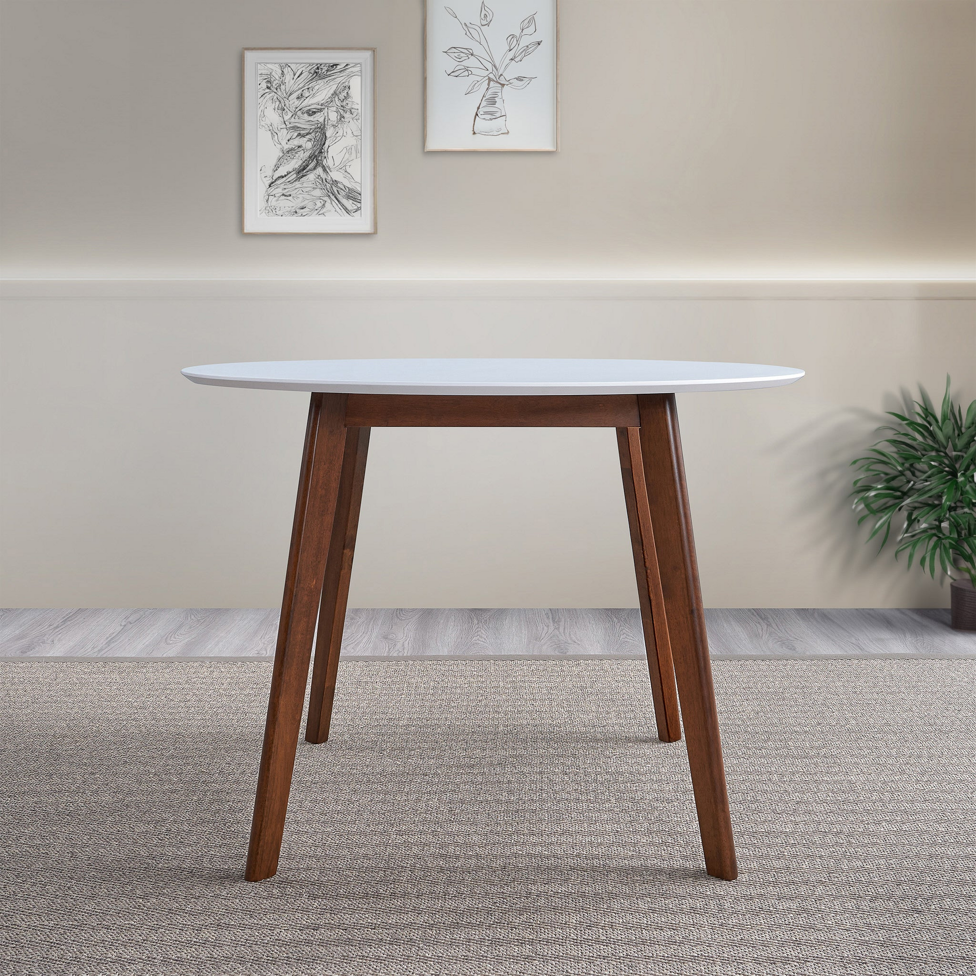Round white dining table with dark wood tapered legs modern midcentury design