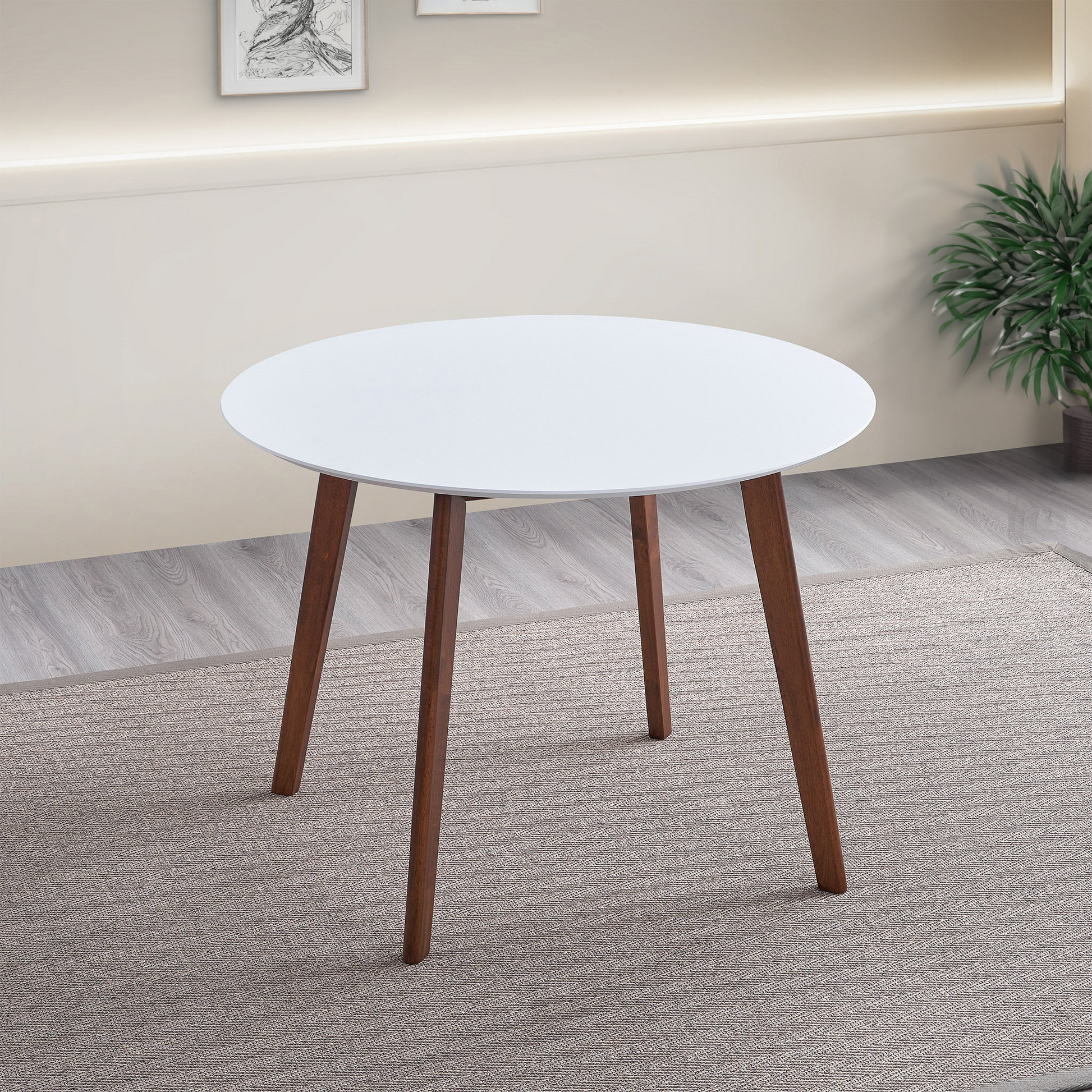 White round dining table with dark wood tapered legs perfect for small spaces