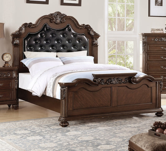 Ornate dark wood bed frame with tufted black leather headboard