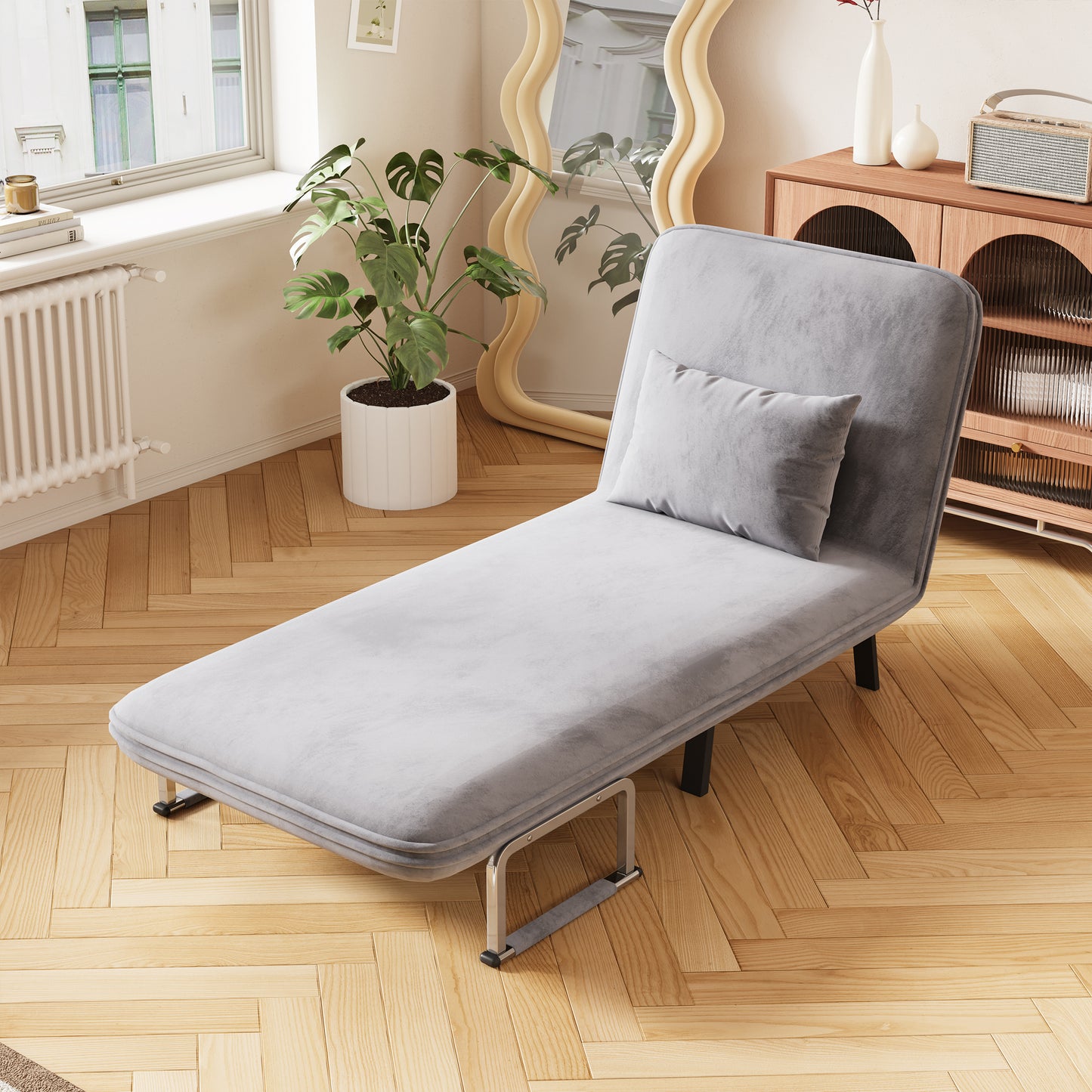 Modern grey velvet chaise lounge with a supportive pillow perfect for relaxation