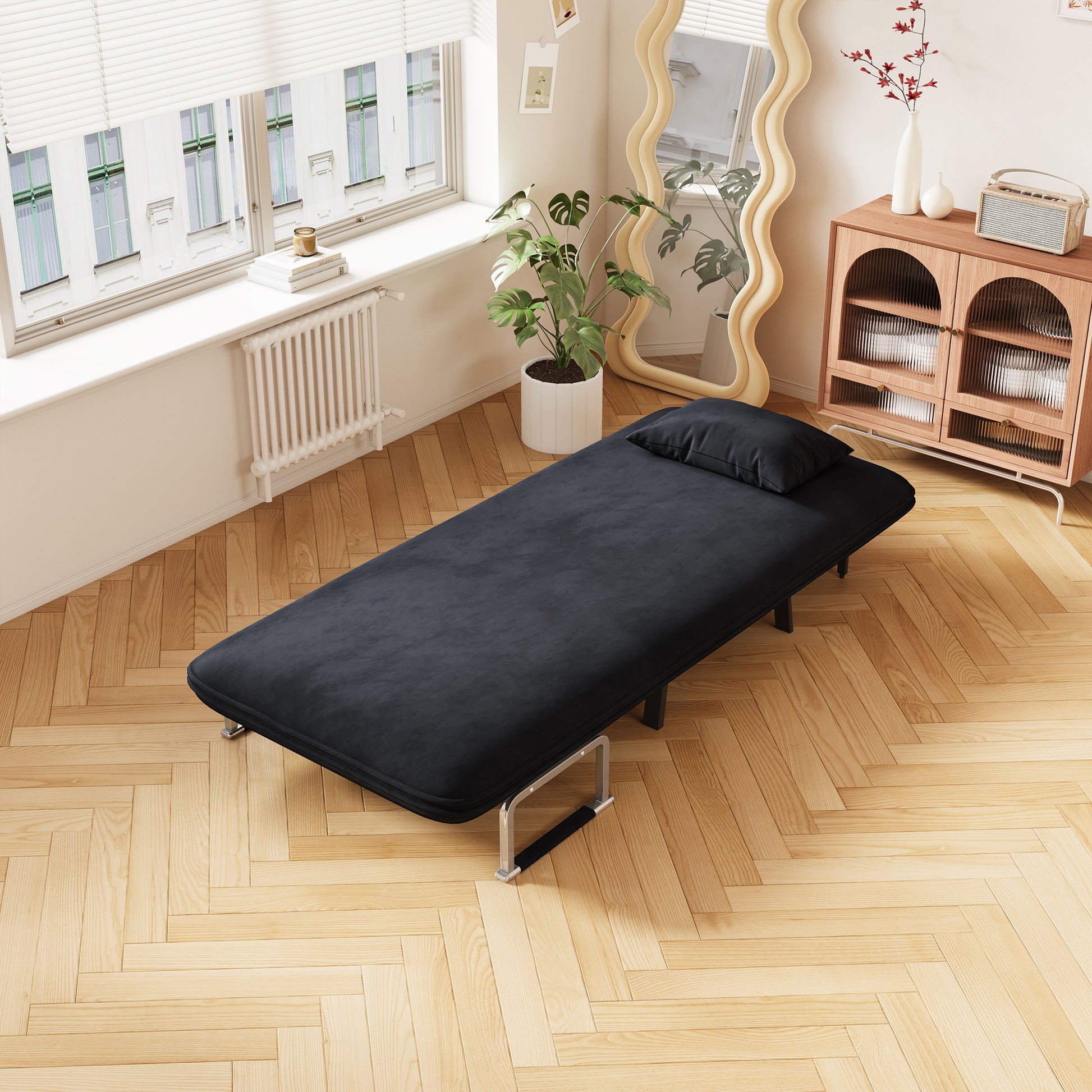 Black velvet sofa bed with chrome legs ideal for small apartments