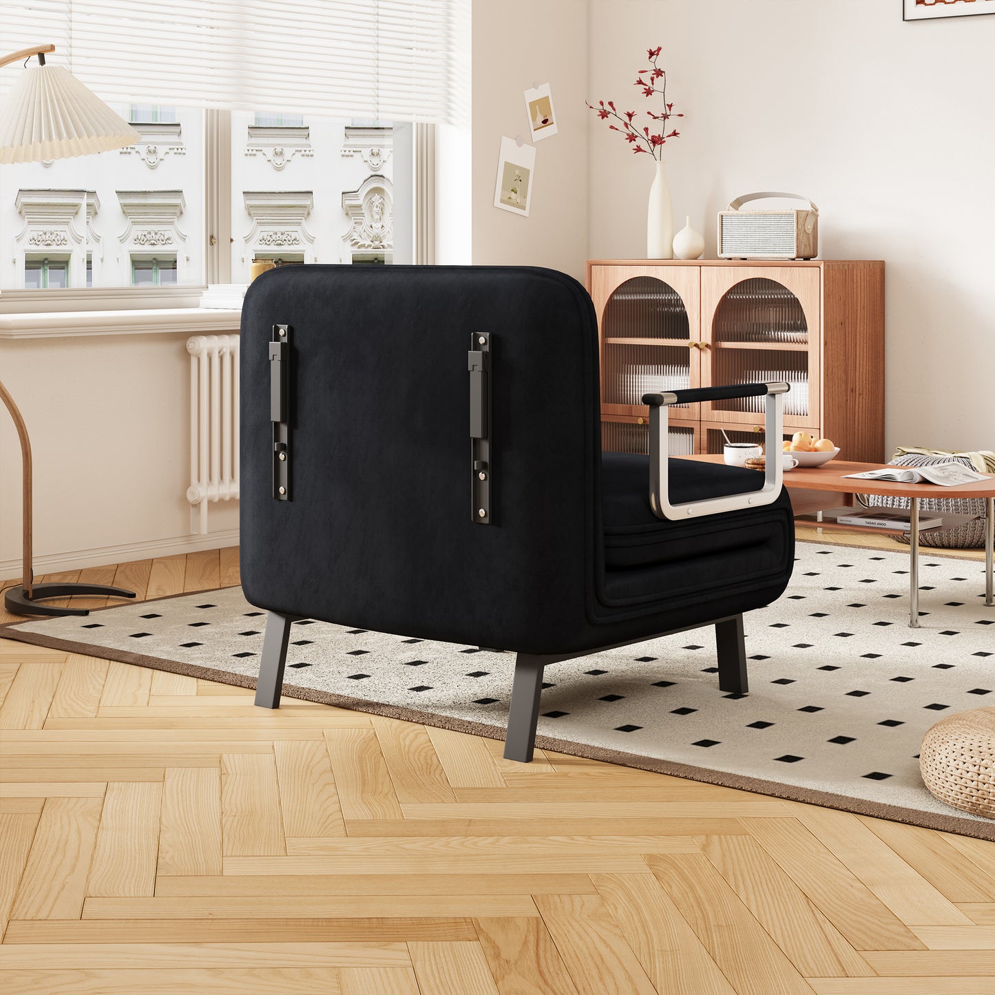 Black velvet armchair with modern metal legs and silver armrests suitable for living rooms
