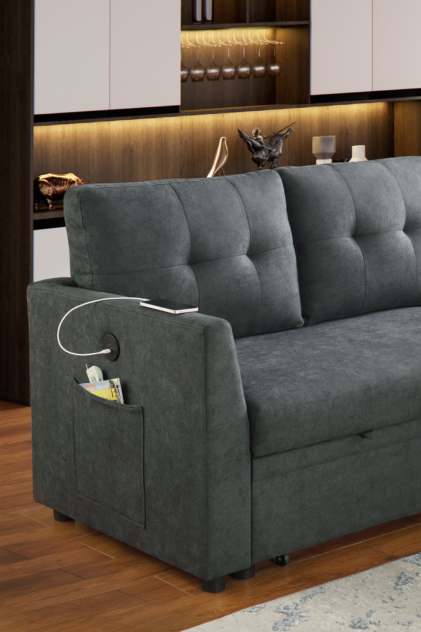 Dark grey tufted sofa with builtin armrest pocket and charging port perfect for modern living rooms