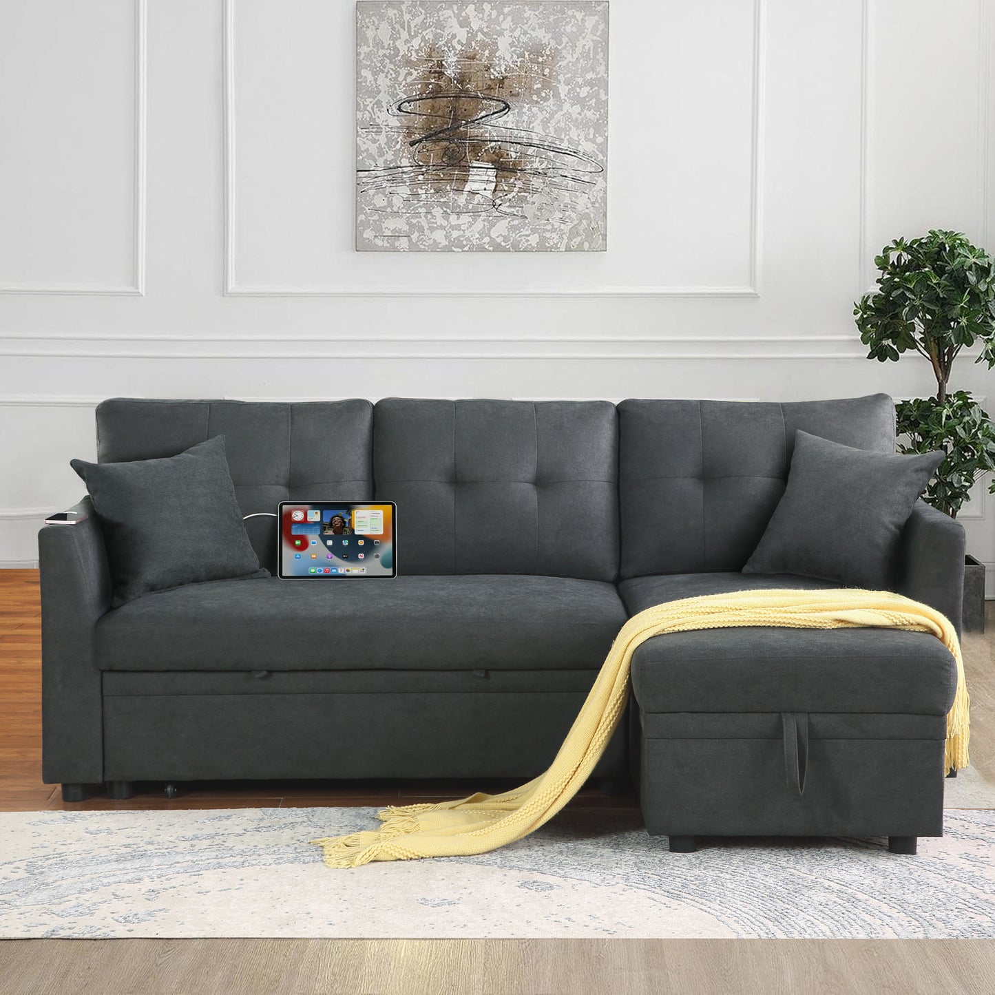 Dark gray sectional sofa with tufted back and removable ottoman featuring builtin charging