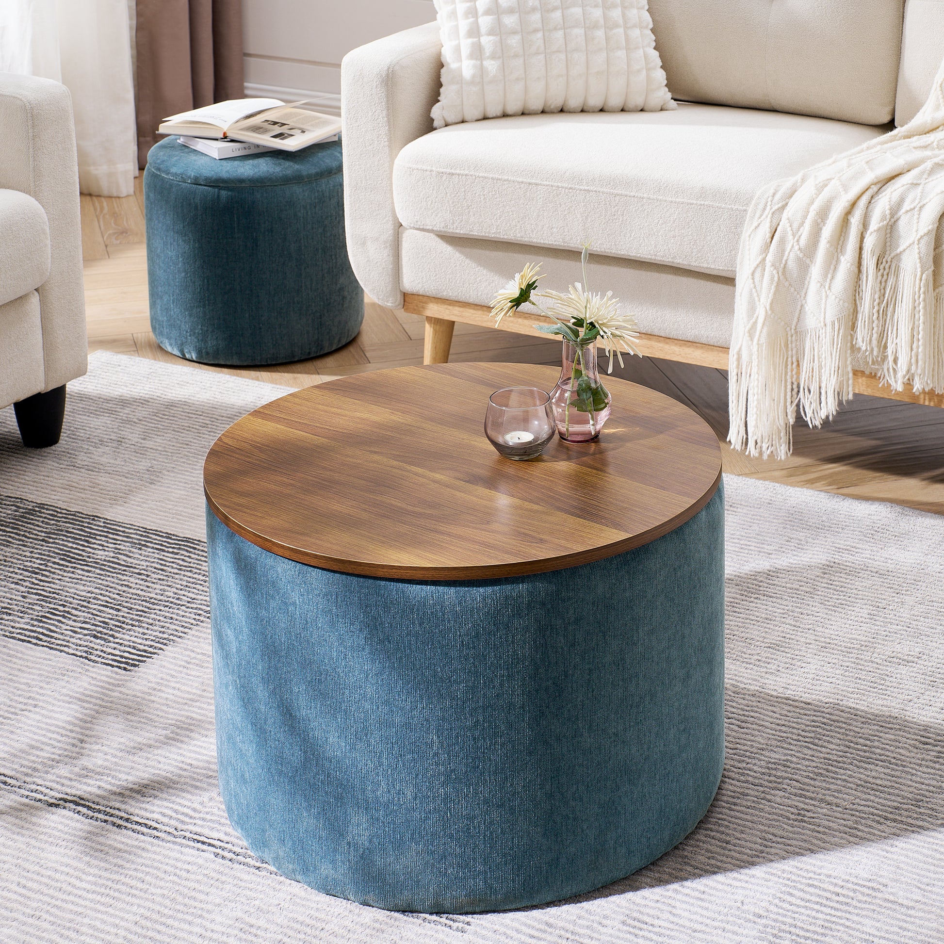 Blue fabric round ottoman with liftoff wood top serving as a coffee table