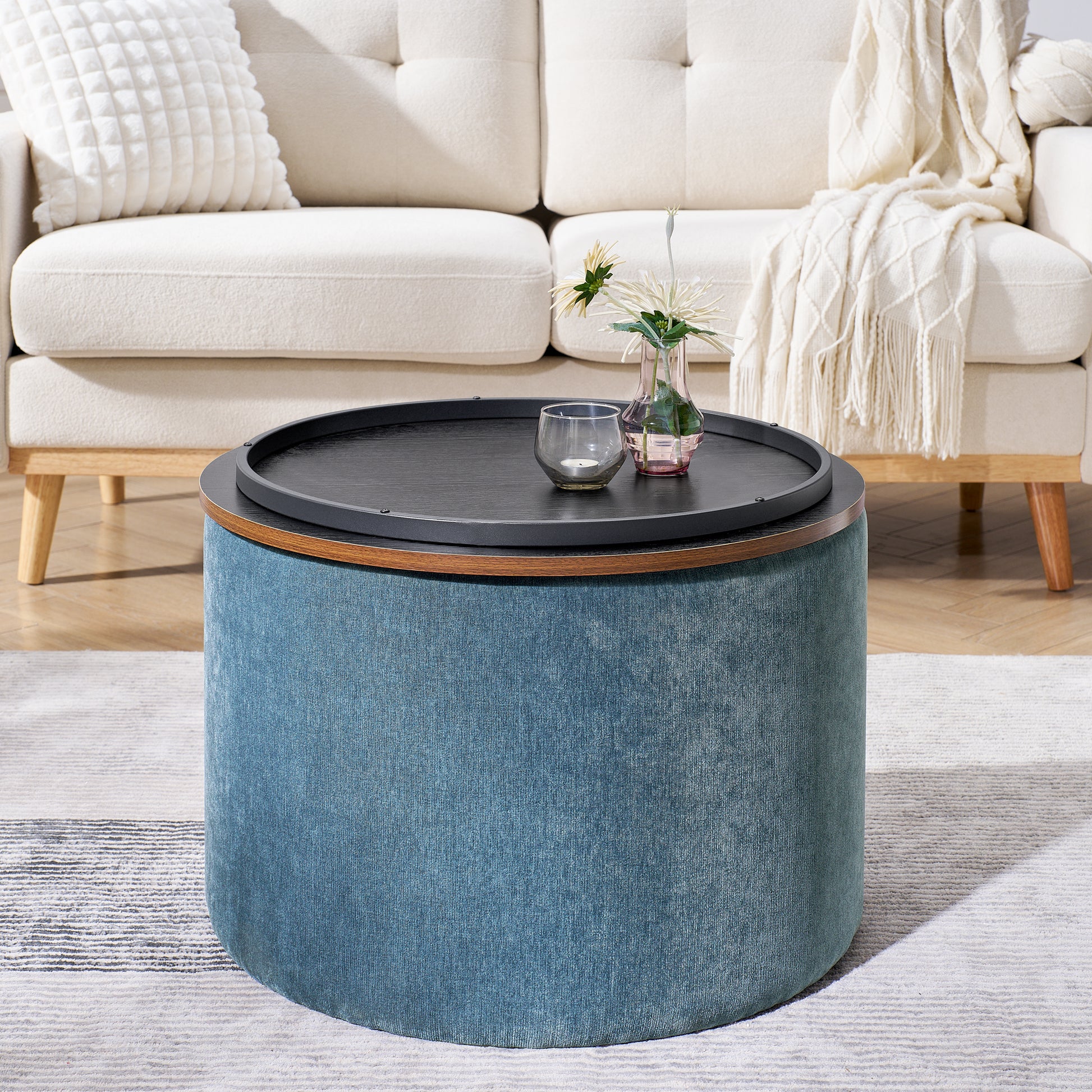 Round blue fabric ottoman coffee table with a black tray top perfect for living rooms