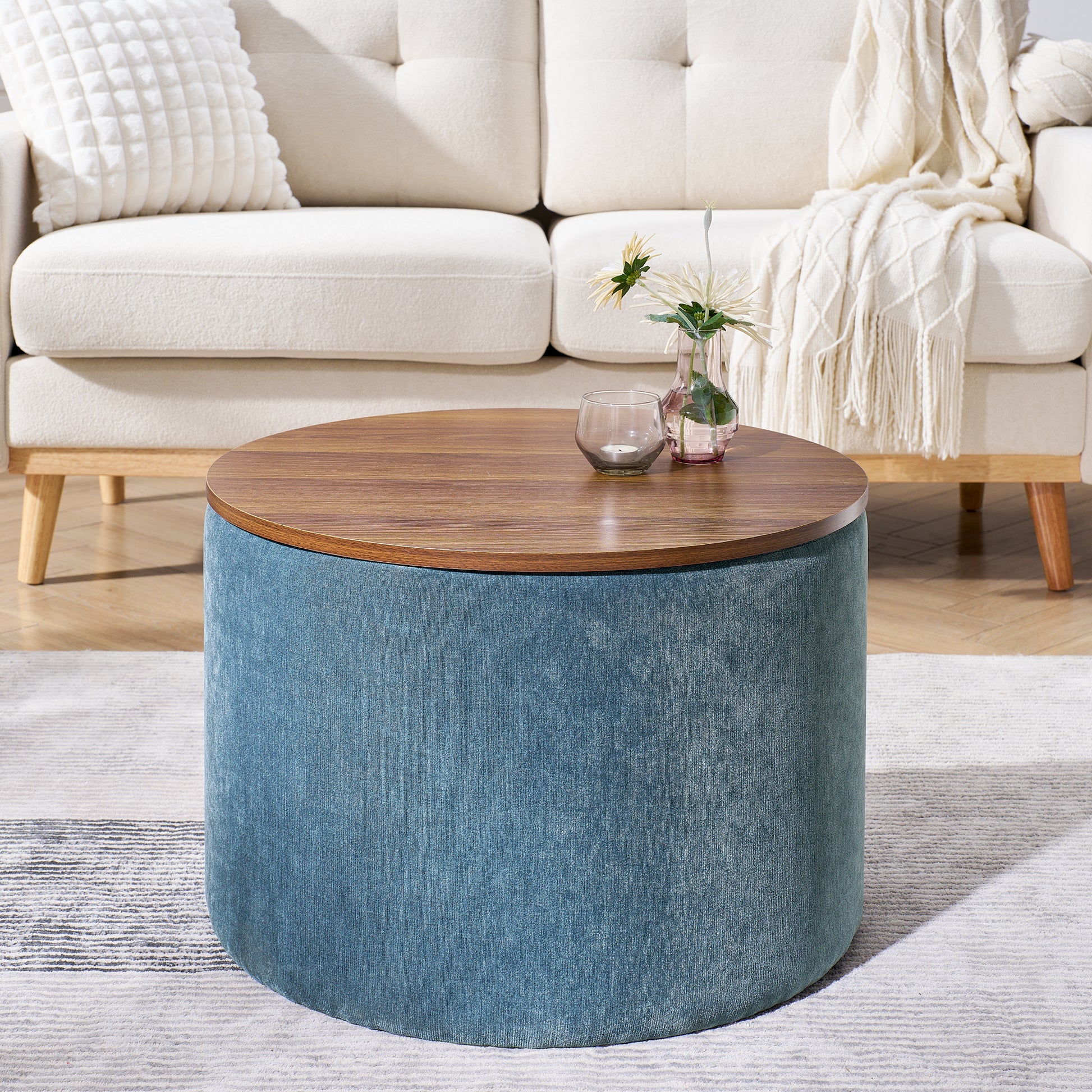 Round teal upholstered ottoman with a wooden lifttop perfect as a coffee table