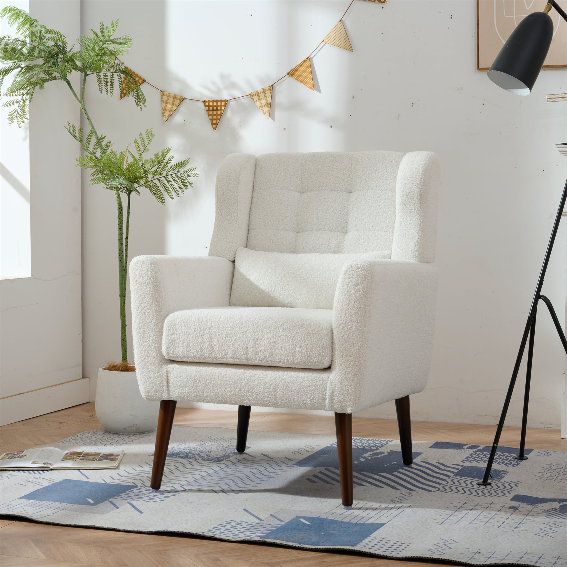 Plush white accent chair with tufted backrest and wooden legs