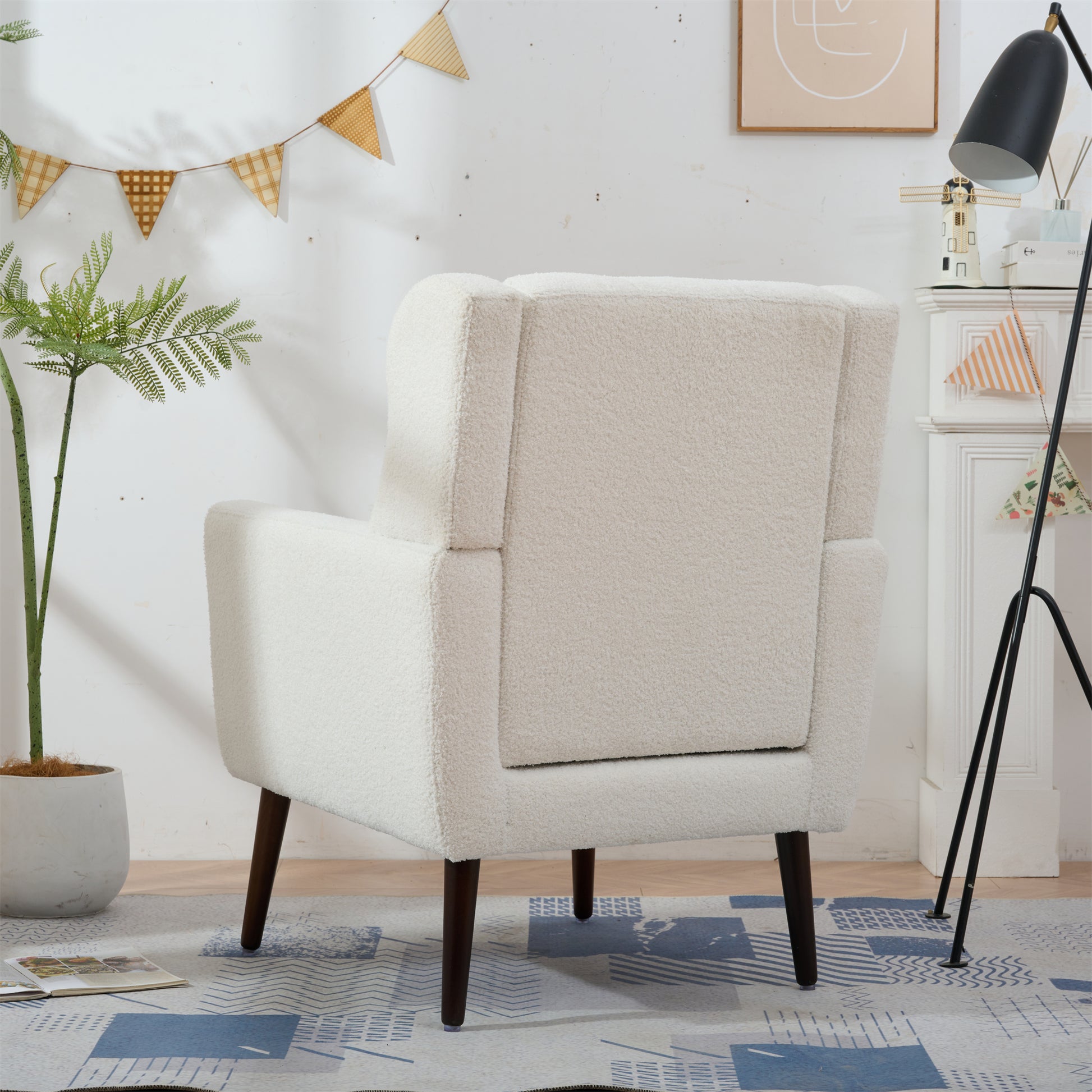 Cream boucle accent chair with dark wood legs for modern living rooms
