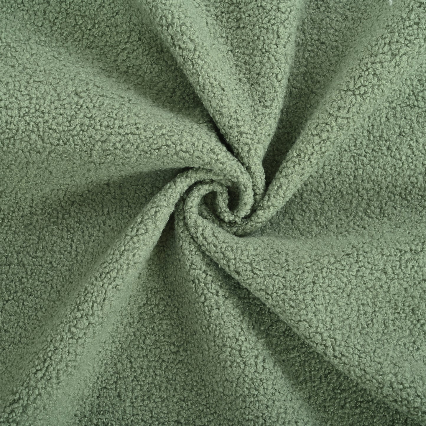 Sage green sherpa fabric with a soft curly texture ideal for cozy apparel