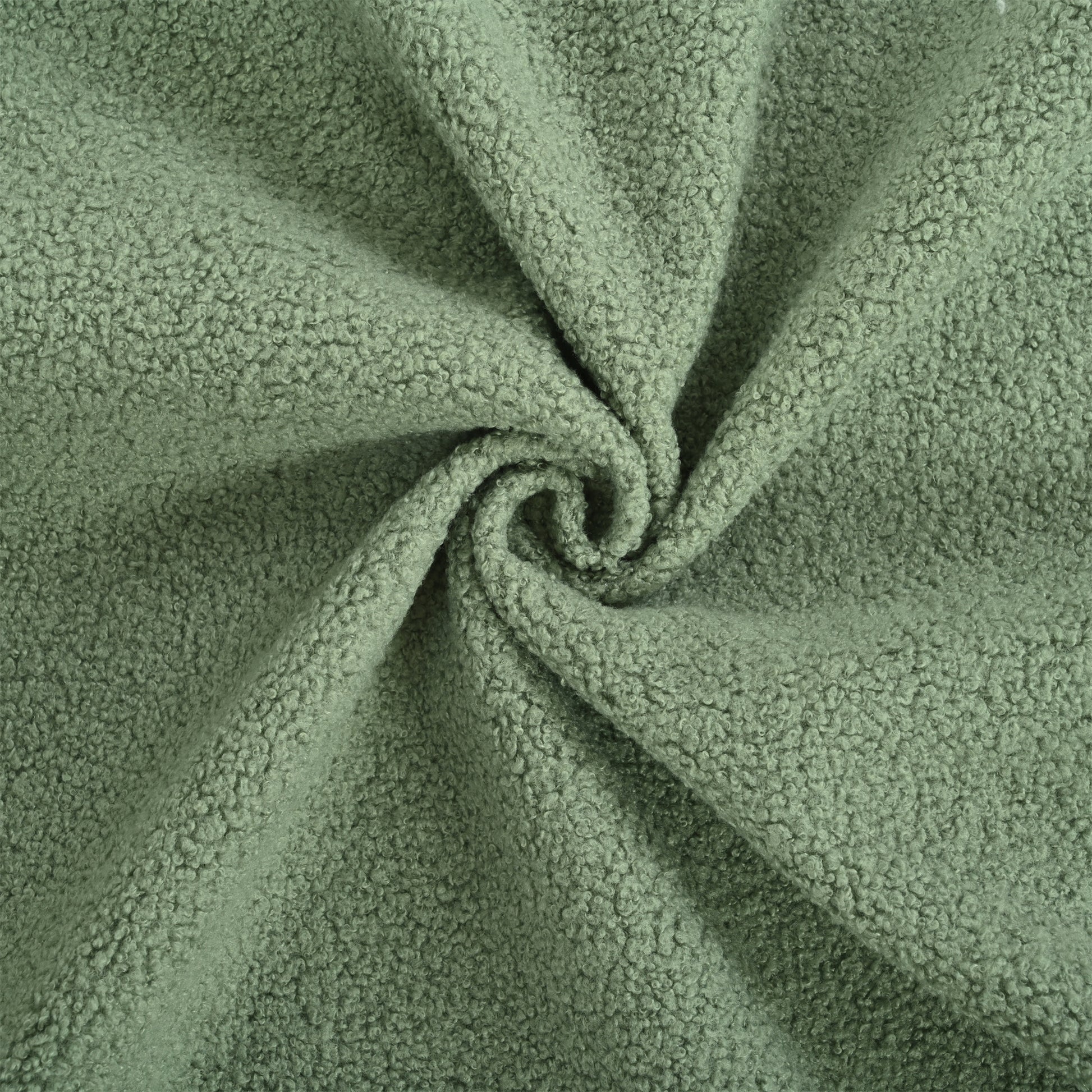 Sage green sherpa fabric with a soft curly texture ideal for cozy apparel