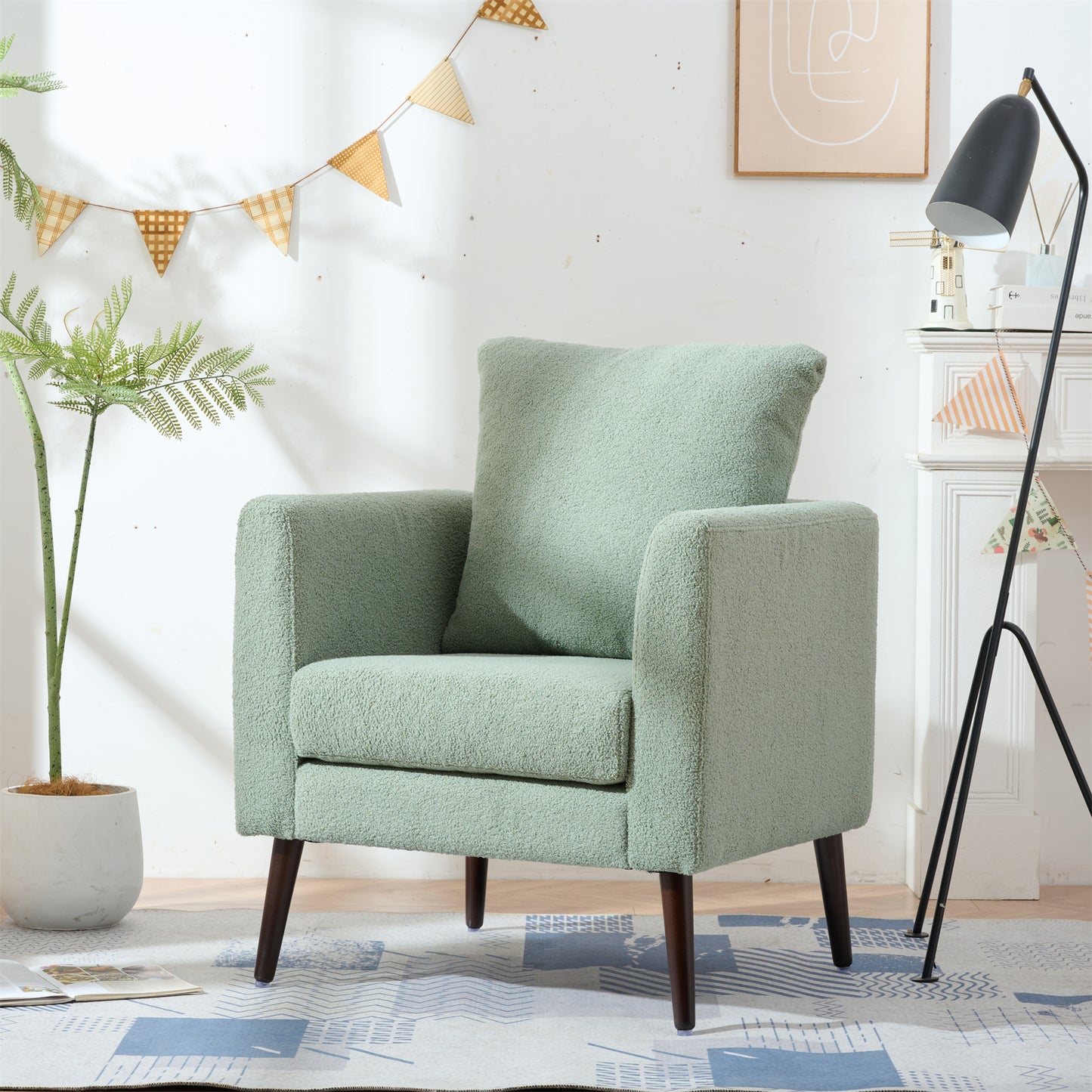 Comfortable textured green armchair with plush fabric and dark wood legs