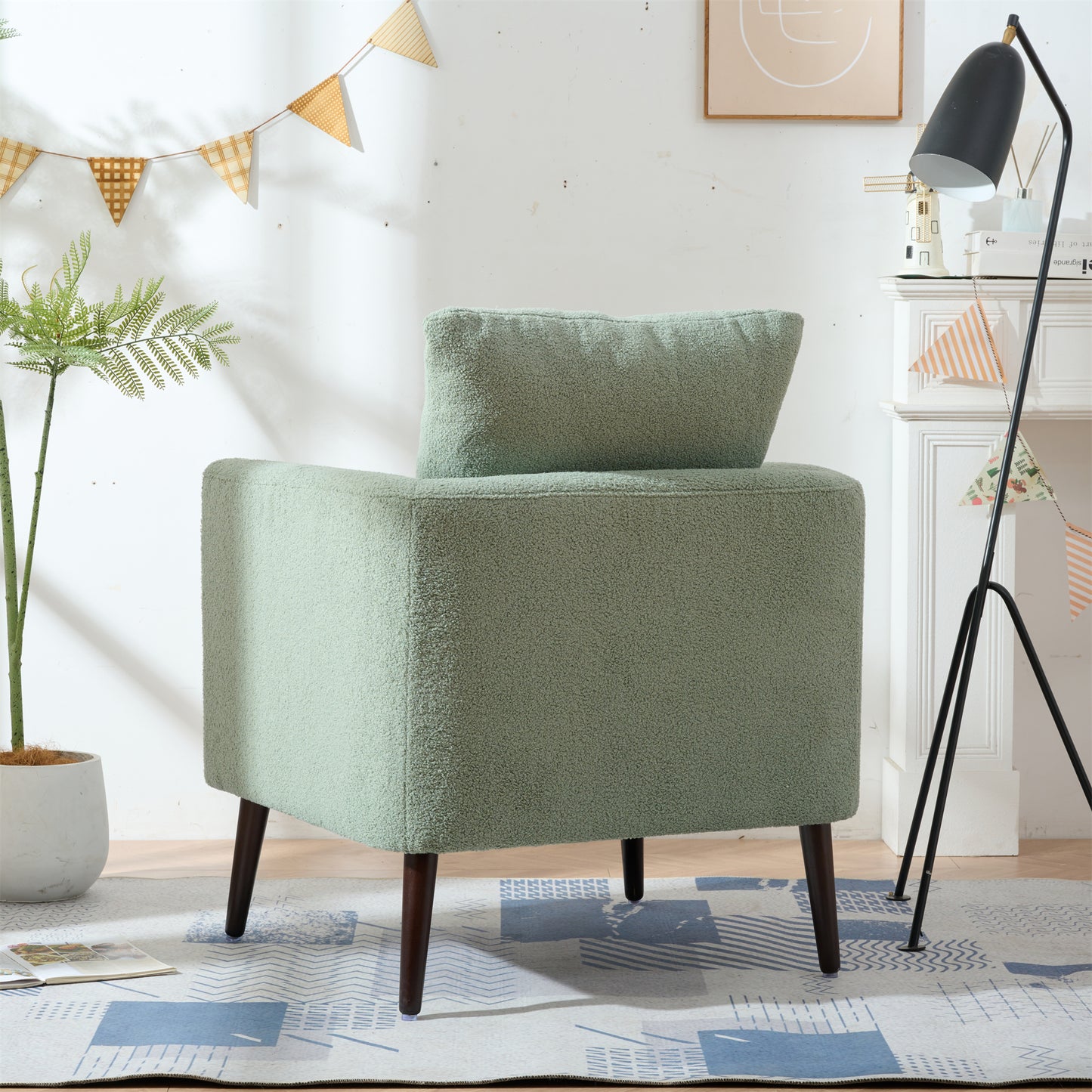 Cozy light green boucle accent chair with plush pillow and dark wood legs