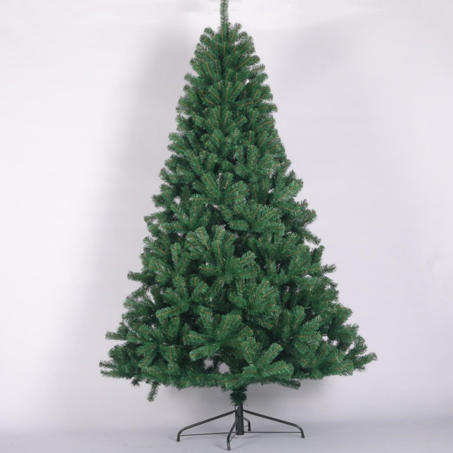 A full green artificial Christmas tree with a metal stand ready for holiday decorating
