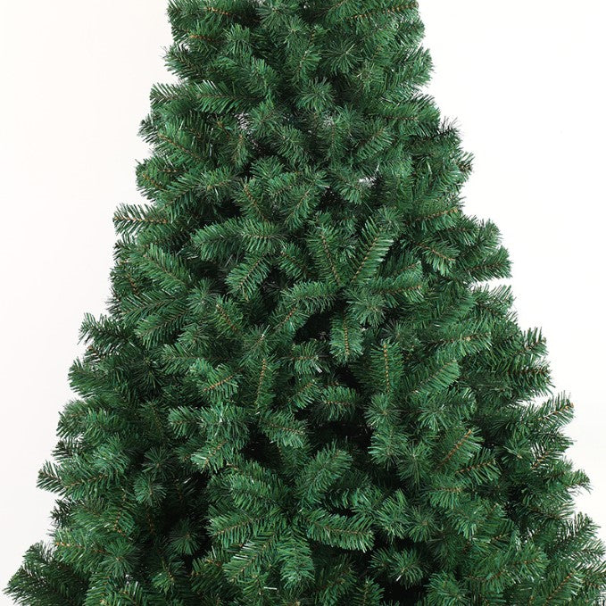 Closeup of a full dense artificial pine Christmas tree with realistic green branches