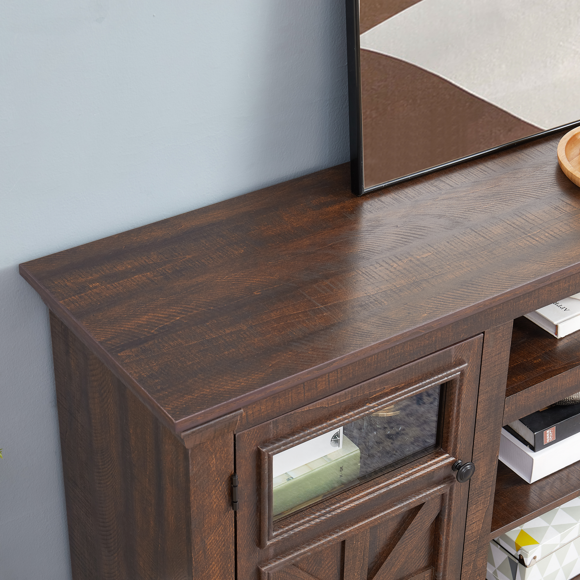 Dark wood TV stand with glasspaneled door and interior shelves