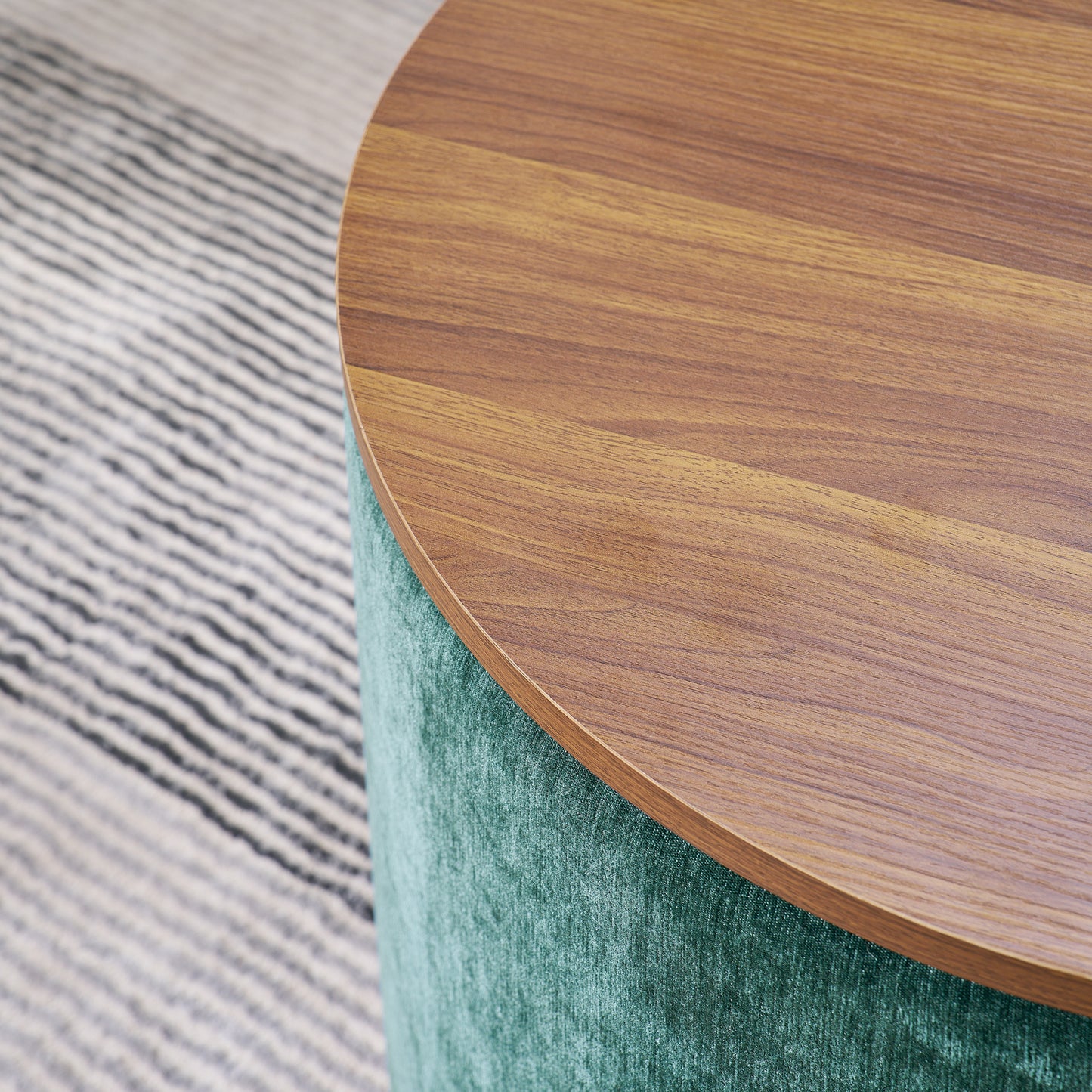 Round ottoman with teal velvet upholstery and natural wood top