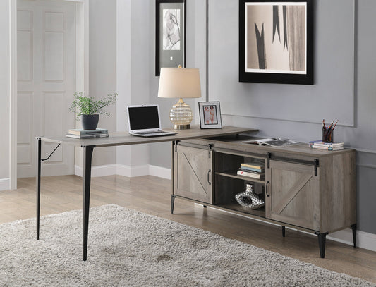 Rustic gray wooden lshaped desk with black metal legs and a sliding barn door cabinet