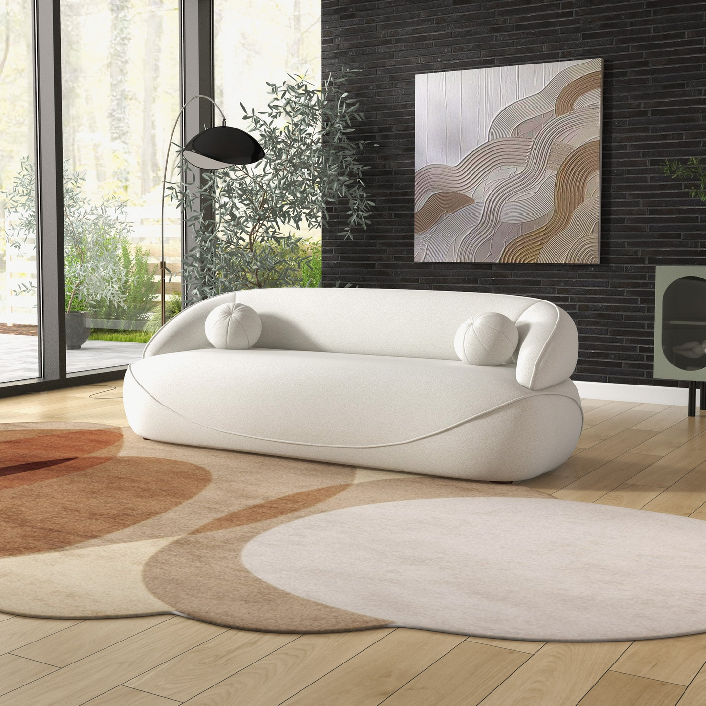 White boucle sofa with rounded arms and two round pillows modern living room seating